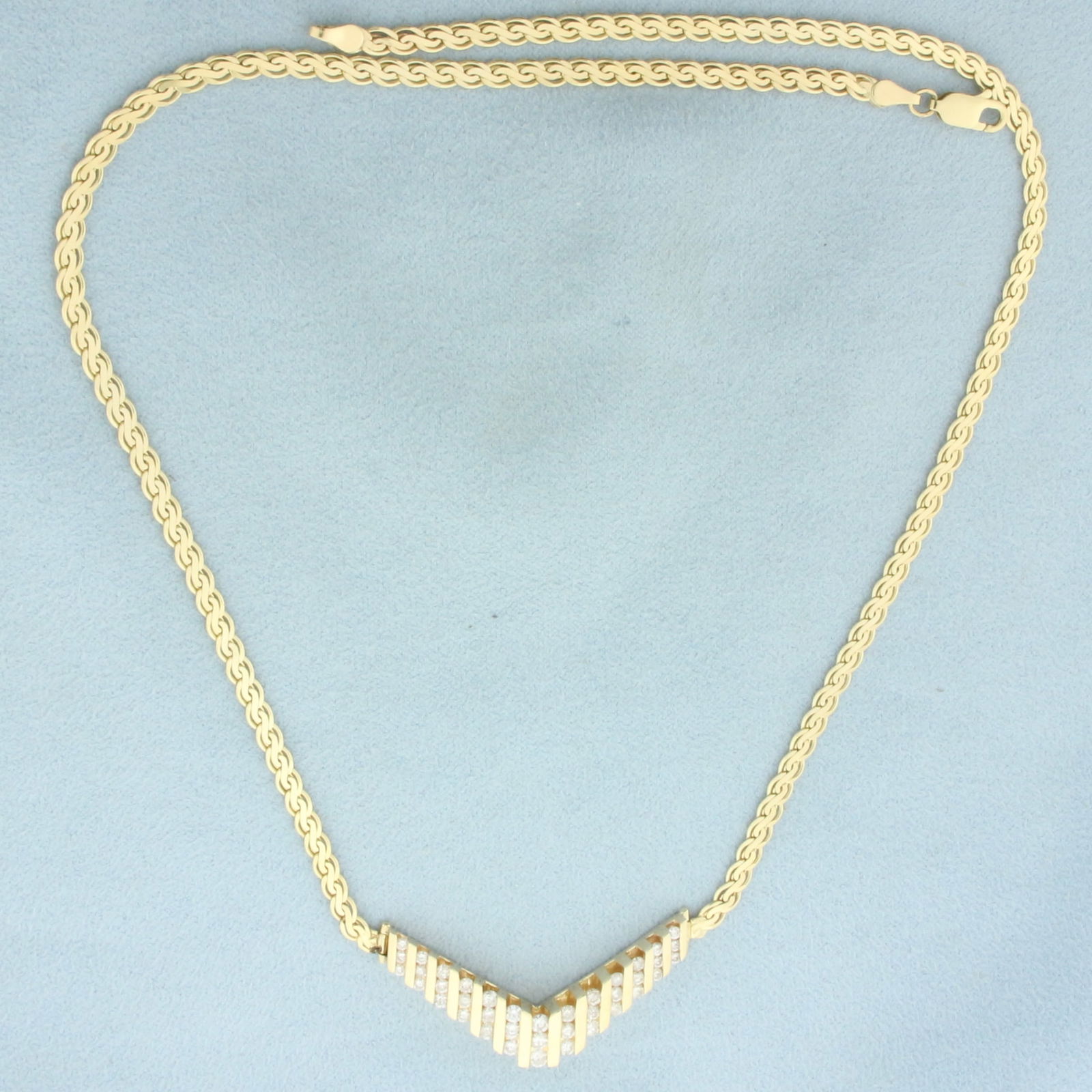 Diamond V Necklace in 14k Yellow Gold: In 14k Yellow Gold. Contains 39 high quality diamonds, 1.5ct TW, H color/I clarity, eye clean, great cut for added brilliance. 18 inches long. 3mm wide. Center V Design is 1.5 inch wide by 3/4 inch ta