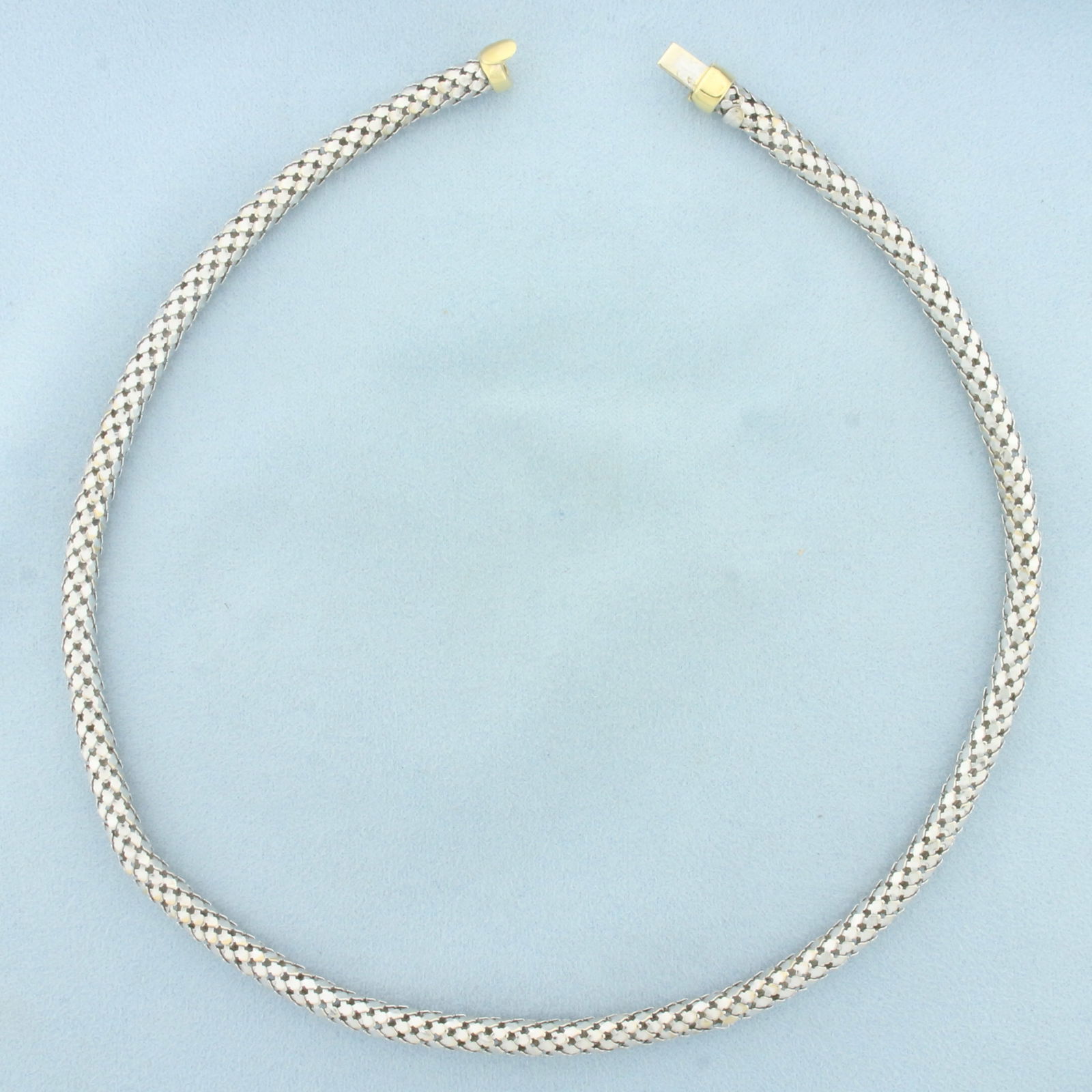 18 Inch Italian Designer Mesh Link Necklace in 18k White and Yellow Gold: In 18k White and Yellow Gold. 18 inches long. 5.6mm wide. Tubular mesh link. Italian made. Slide clasp. 29.3g.