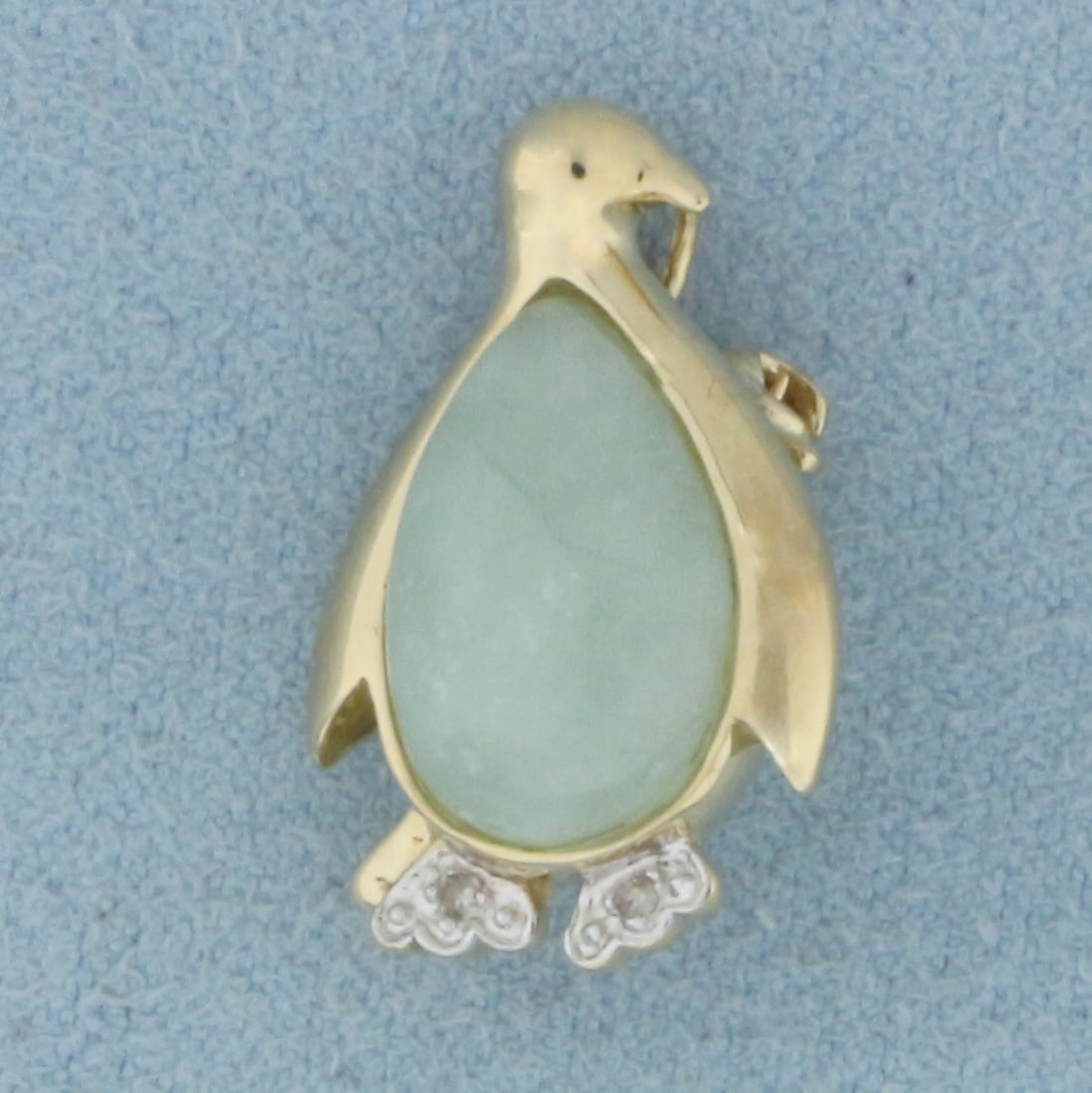 Penguin Jade and Diamond Pendant or Brooch in 10k Yellow Gold: In 10k Yellow Gold. Contains one 14mm high quality natural Jade gemstone with beautiful green color. Also contains two high quality 1/2pt diamonds. 7/8 inch long, 1/2 inch wide. Can be worn as brooch