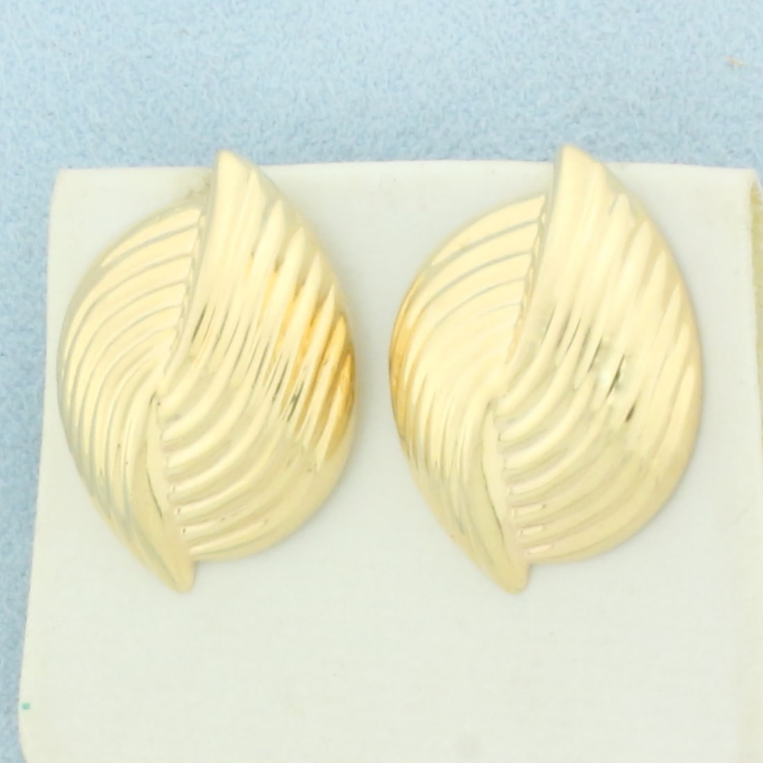 Puffy Ridged Statement Earrings in 14k Yellow Gold: In 14k Yellow Gold. 1 inch long. 5/8 inch wide. Friction backs. 3.5g.