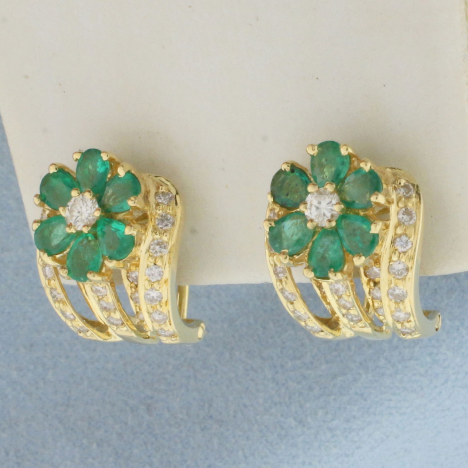 Emerald and Diamond Flower Earrings in 18k Yellow Gold: In 18k Yellow Gold. Contains two .10ct and forty-six .01ct high quality diamonds, SI clarity/H color. Also contains twelve 4mm high quality natural Emerald gemstones with vivid color and excellent cla