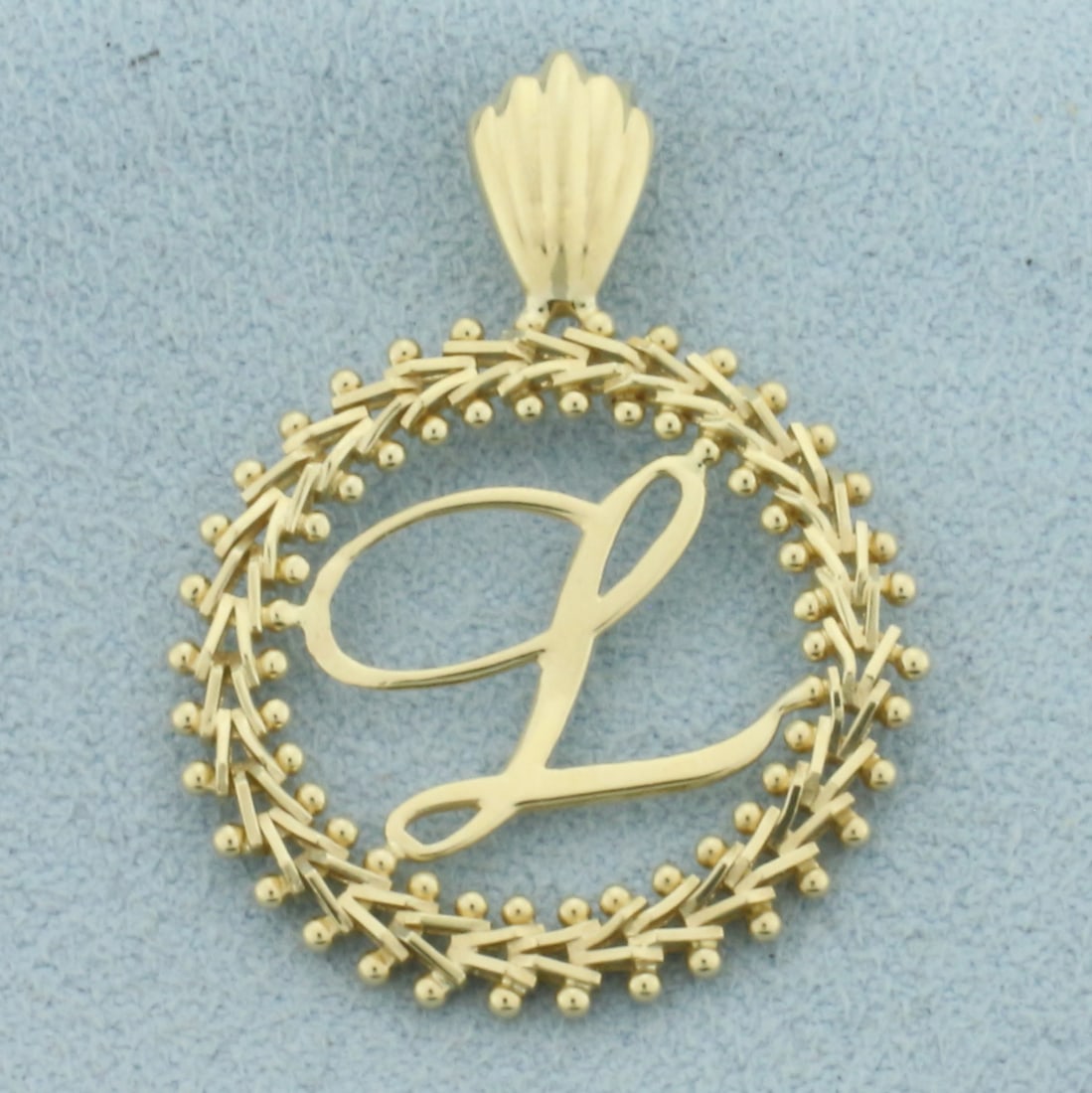 Initial L Pendant in 14k Yellow Gold: In 14k Yellow Gold. 1 1/4 inch long. 7/8 inch wide. 2.6g.