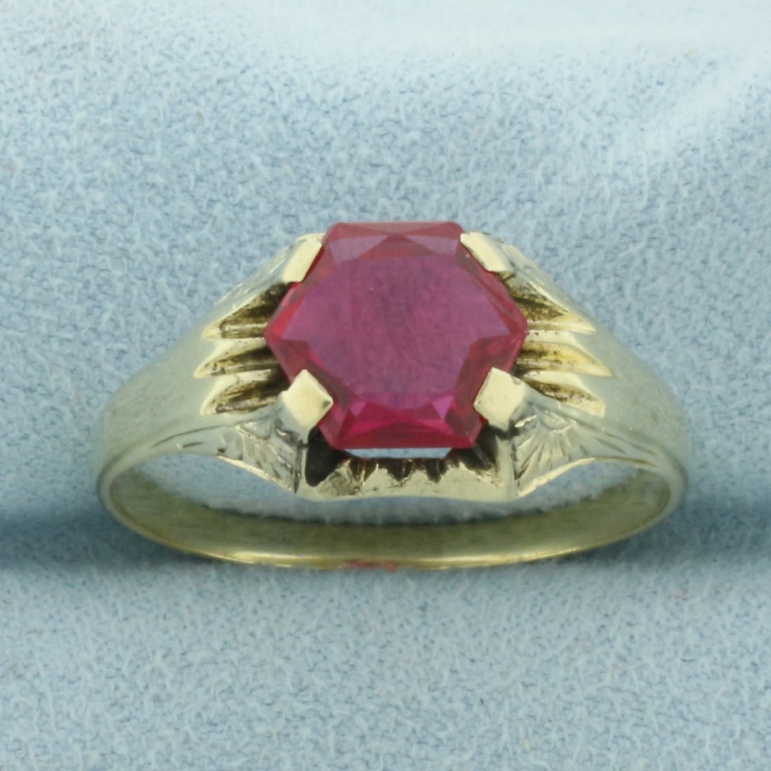 Mens Hexagon Lab Ruby Ring in 14k Yellow Gold: In 14k Yellow Gold. Contains one 10mm high quality fancy cut hexagon Lab Ruby gemstone with vibrant color and excellent clarity. Size 13.25. 5.1g.