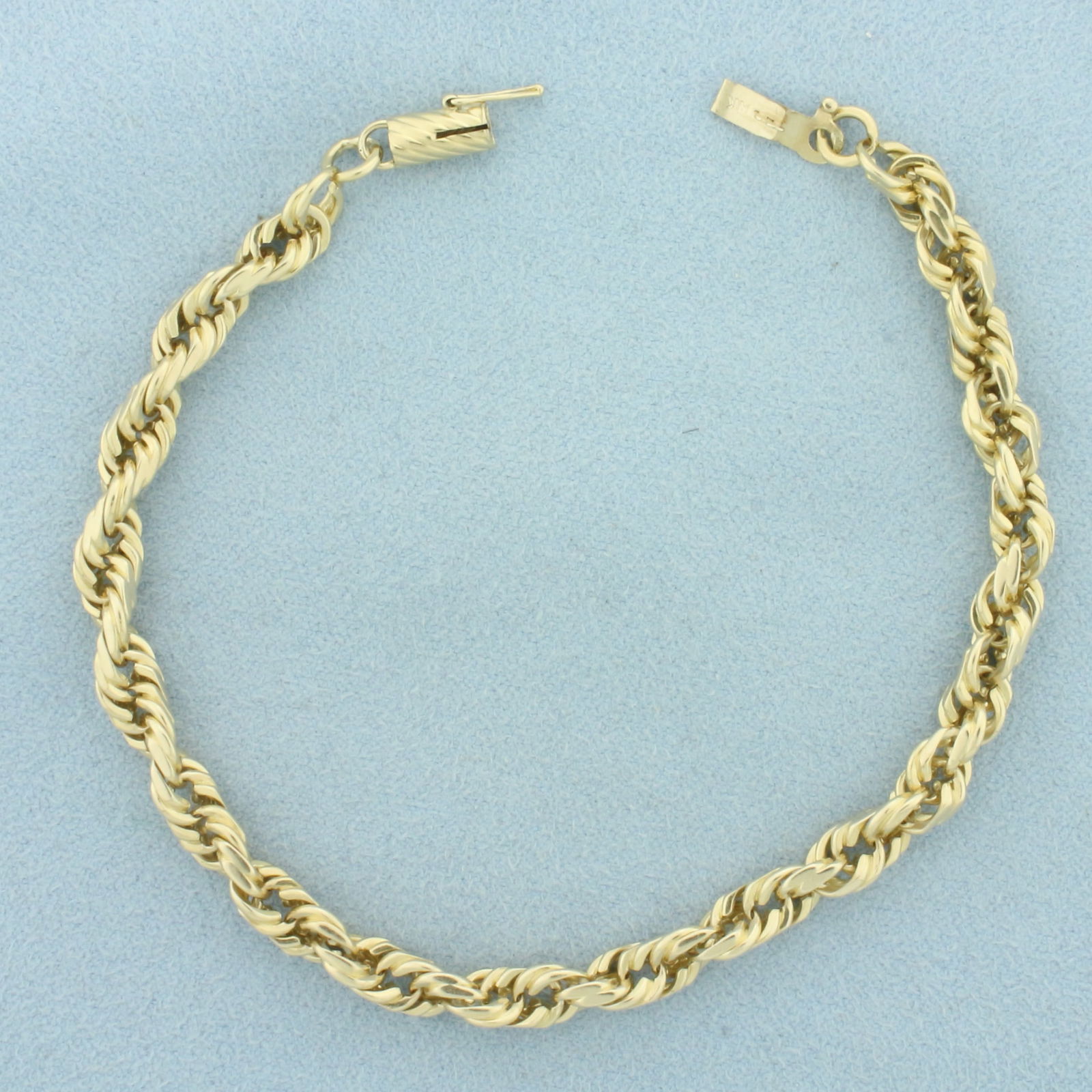 Rope Link Bracelet in 14k Yellow Gold: In 14k Yellow Gold. 8 inches long. 5mm wide. Barrel clasp with safety latch. 15.6g.