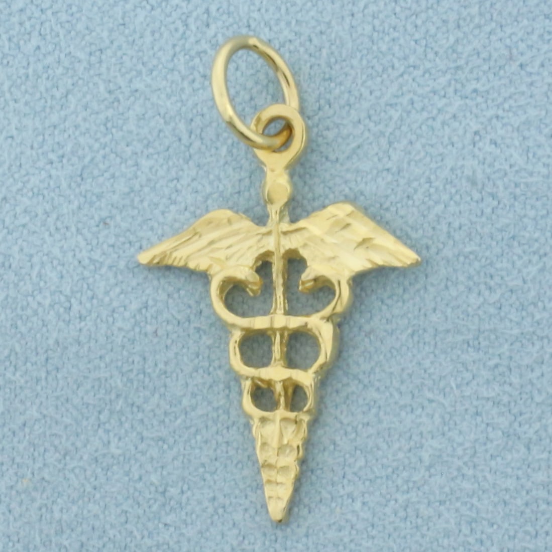 Caduceus Staff of Hermes Medical Charm in 14k Yellow Gold: In 14k Yellow Gold. 1 1/8 inch long (including jump ring). 5/8 inch wide. 1.6g.