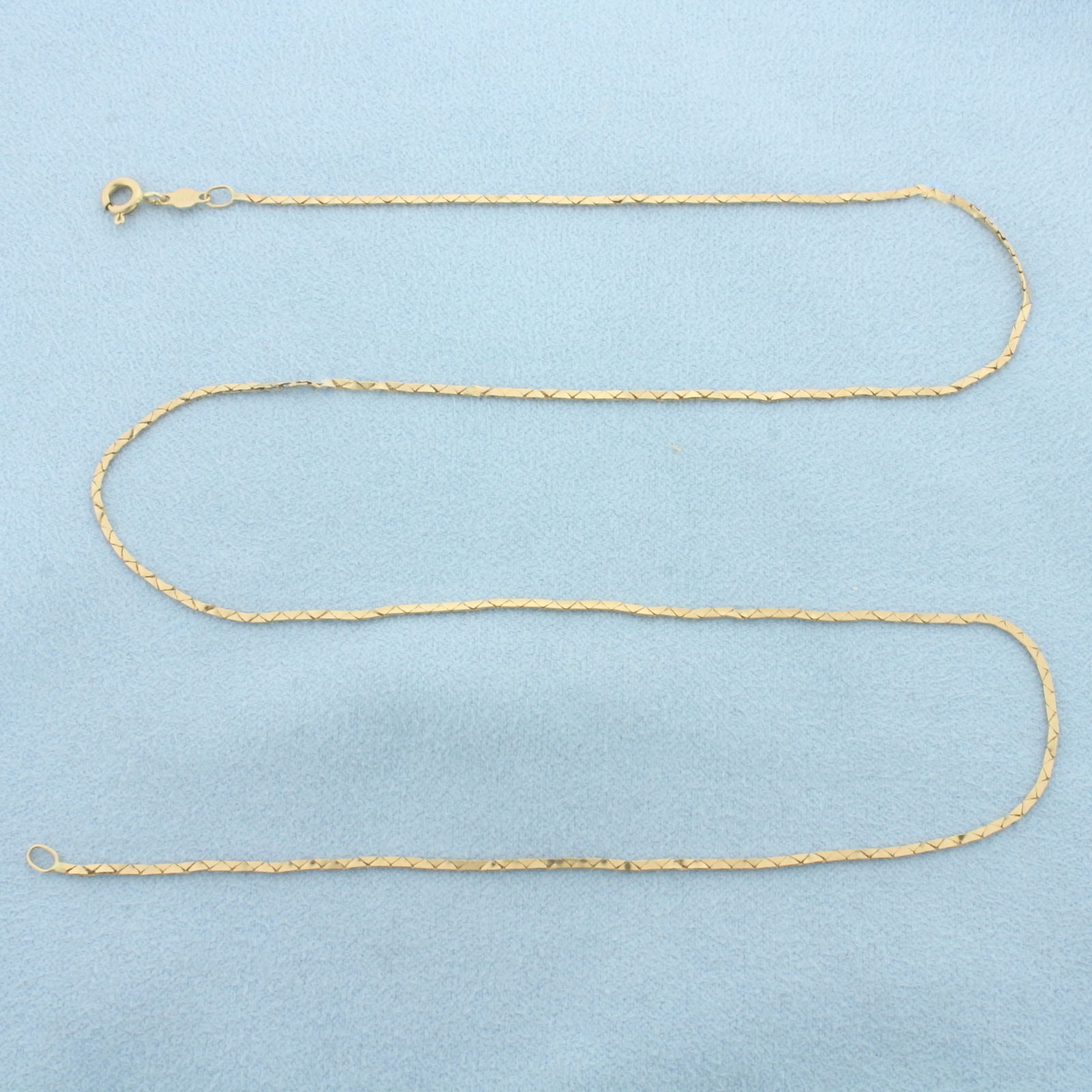 18 Inch Cobra Link Chain Necklace in 14k Yellow Gold: In 14k Yellow Gold. 18 inches long. 1.1mm wide. Spring clasp. 2.3g.