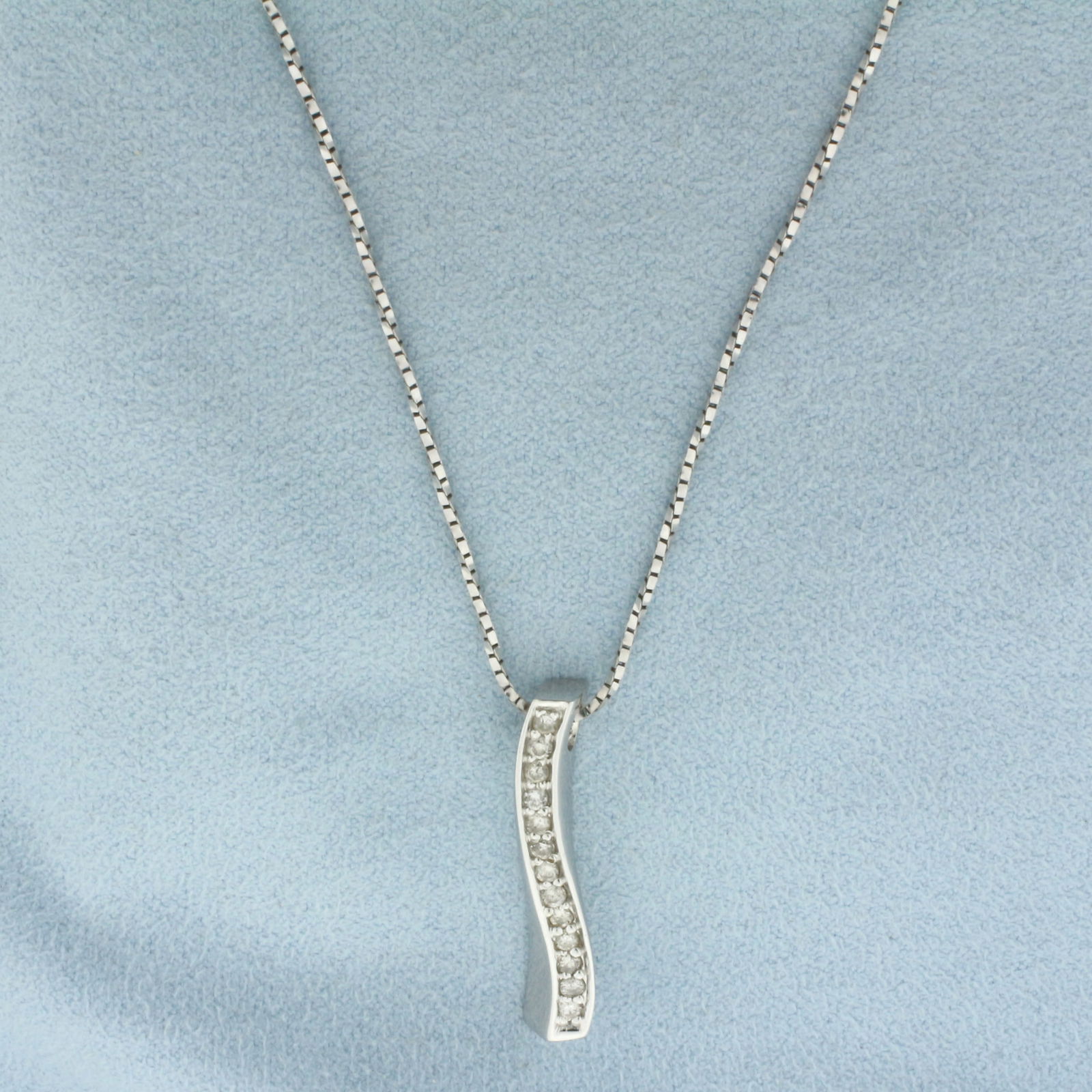 Italian Diamond Journey Necklace in 14k White Gold: In 14k White Gold. Contains thirteen high quality .02ct diamonds, H color/I clarity. Twisting Box Link Chain is 20 inches long. 1.1mm wide. Slide is 1 1/8 inch long, 1/4 inch wide. Lobster clasp. 6.4g
