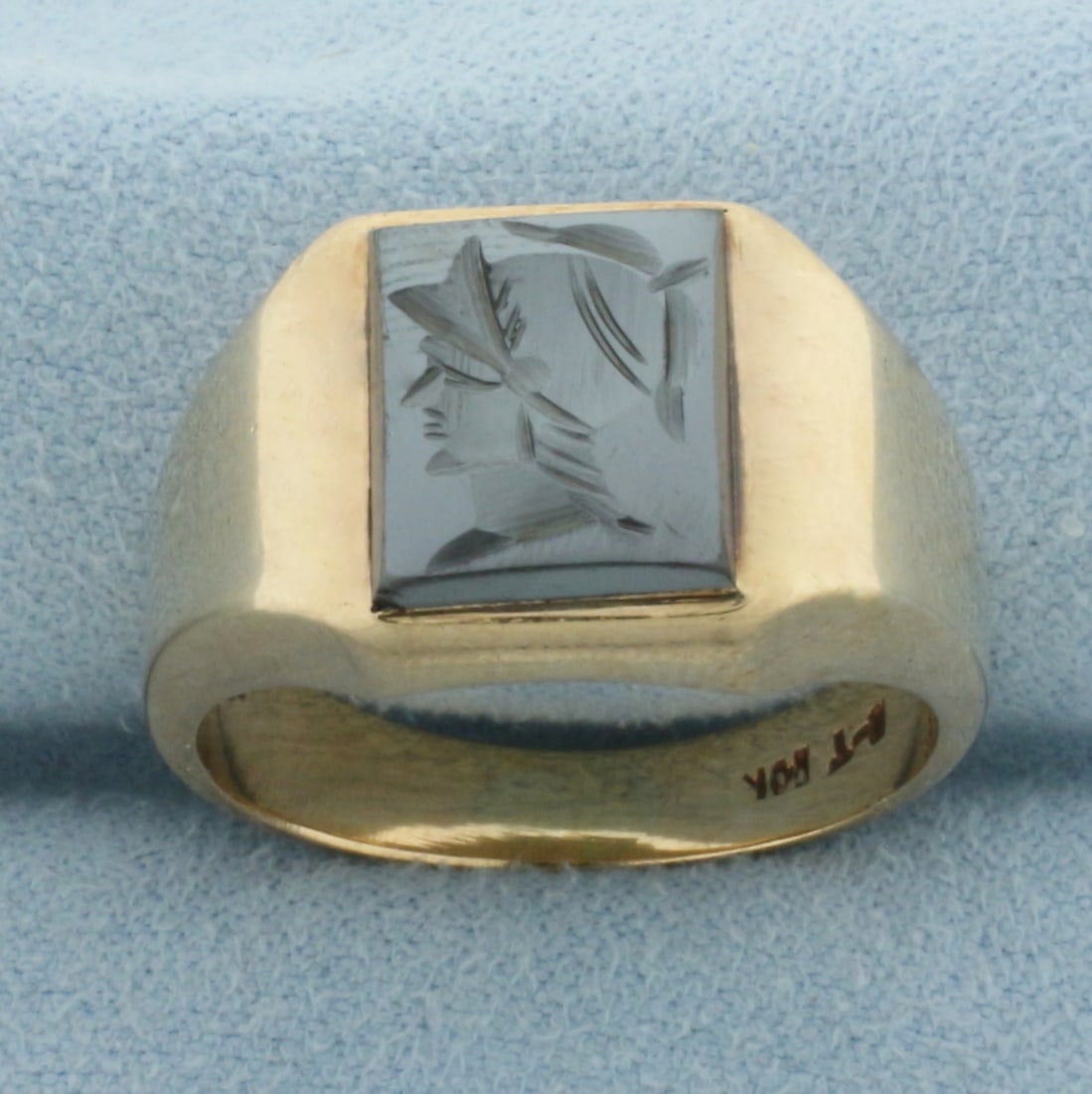 Hematite Roman Spartan Mens Ring in 10k Yellow Gold: In 10k yellow gold. 13.3mm wide at center. Contains one 11.5mm by 9.5mm hand carved hematite gemstone. Size 10. 8.0g.