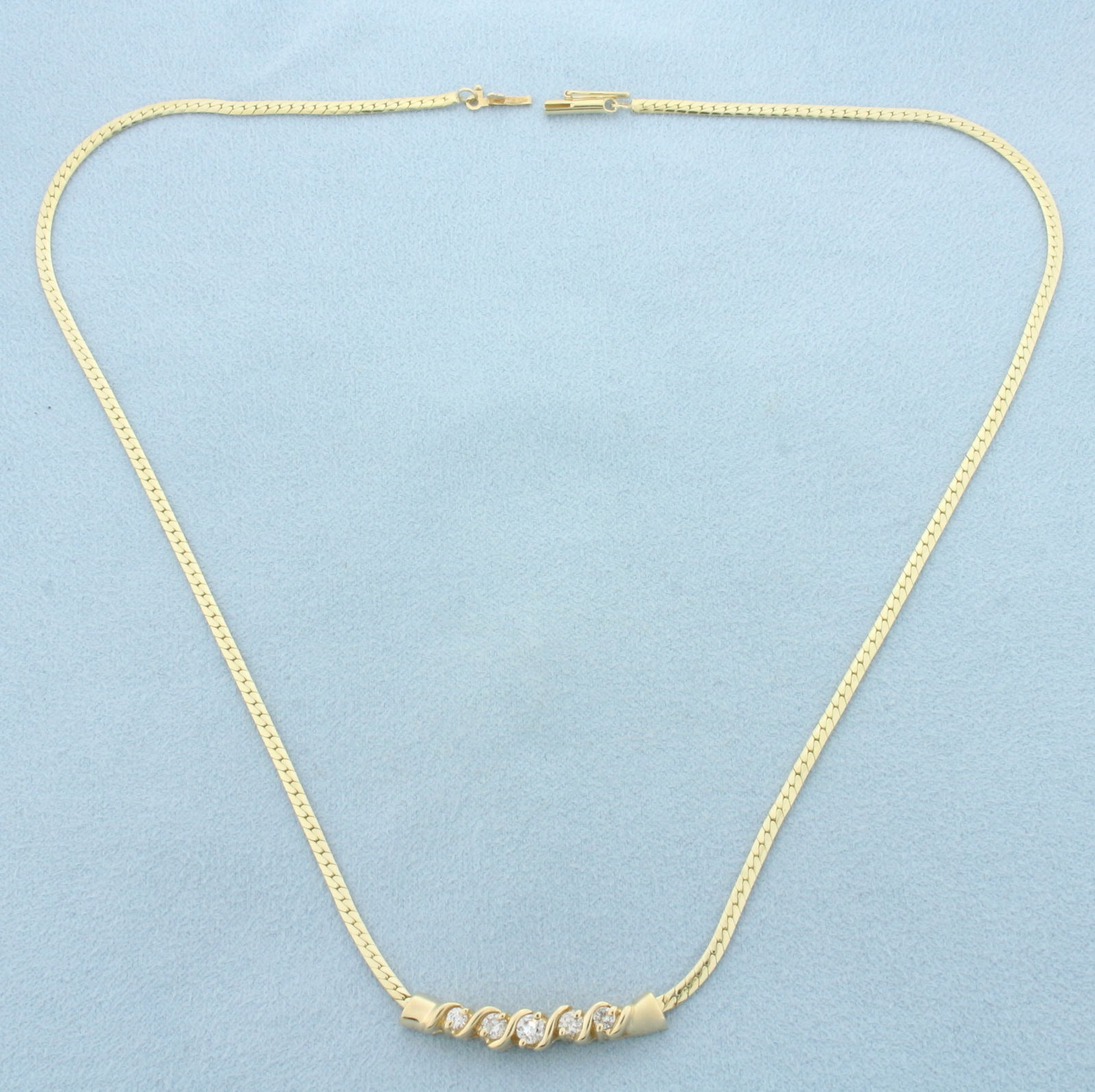 Diamond Herringbone Link Necklace in 14k Yellow Gold: In 14k Yellow Gold. Contains one 1/8ct, two 1/10ct, and two 1/20ct high quality round brilliant diamonds, H color/I clarity. 17 inches long. 2mm wide. Barrel clasp with safety latch. 8.3g.