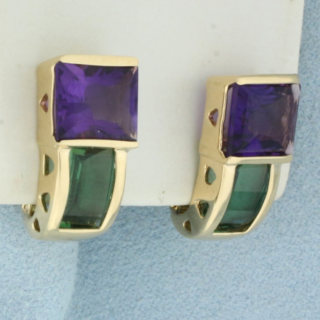 Amethyst and Green Tourmaline Earrings in 14k Yellow Gold: In 14k Yellow Gold. Contains two 10x8mm high quality rectangular cut natural Amethyst gemstones, with vibrant color and excellent clarity. Also contains two 8.5x5.5mm high quality fancy cut natural Gr