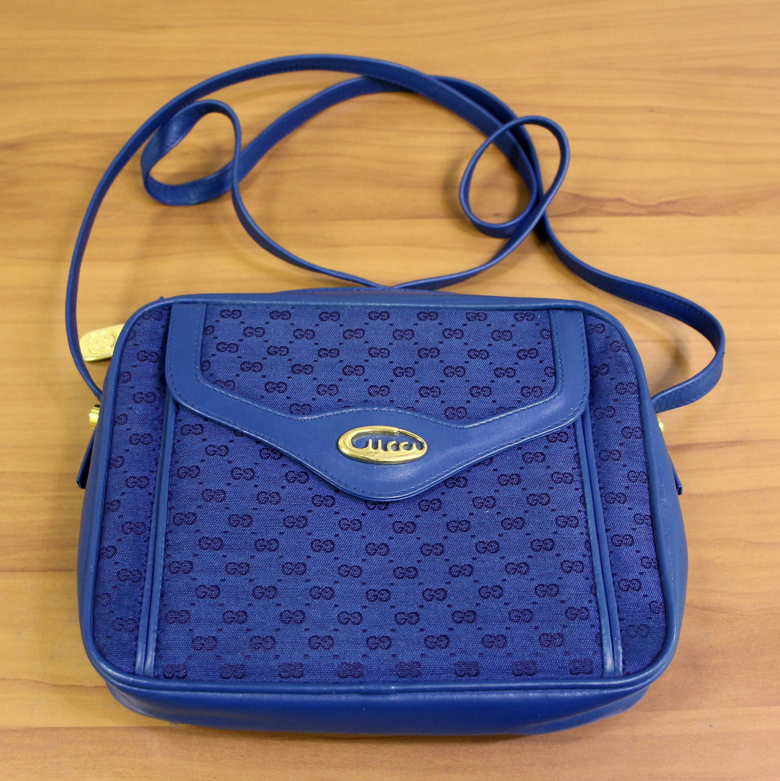 Vintage Gucci Blue Crossbody Camera Bag: Rare style and color, includes original yellow Gucci Boutique dustbag. Unique gold toned logo hardware. 8.5" wide x 7" tall and 2.25" deep with 23" strap drop. Professionally cleaned - in beautiful co