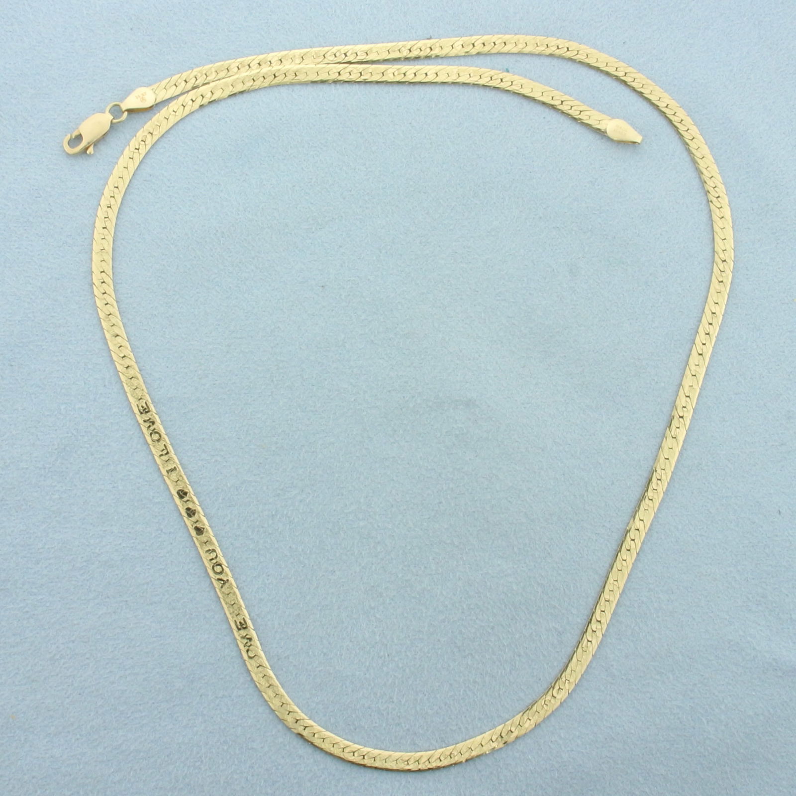 19 Inch I Love You Reversible Herringbone Link Chain Necklace in 14k Yellow Gold: In 14k Yellow Gold. 19 inches long. 1/8 inch wide. Secret message on one side: I LOVE YOU that appears when viewed at an angle. High polish on reverse side. Lobster clasp. 8.7g.