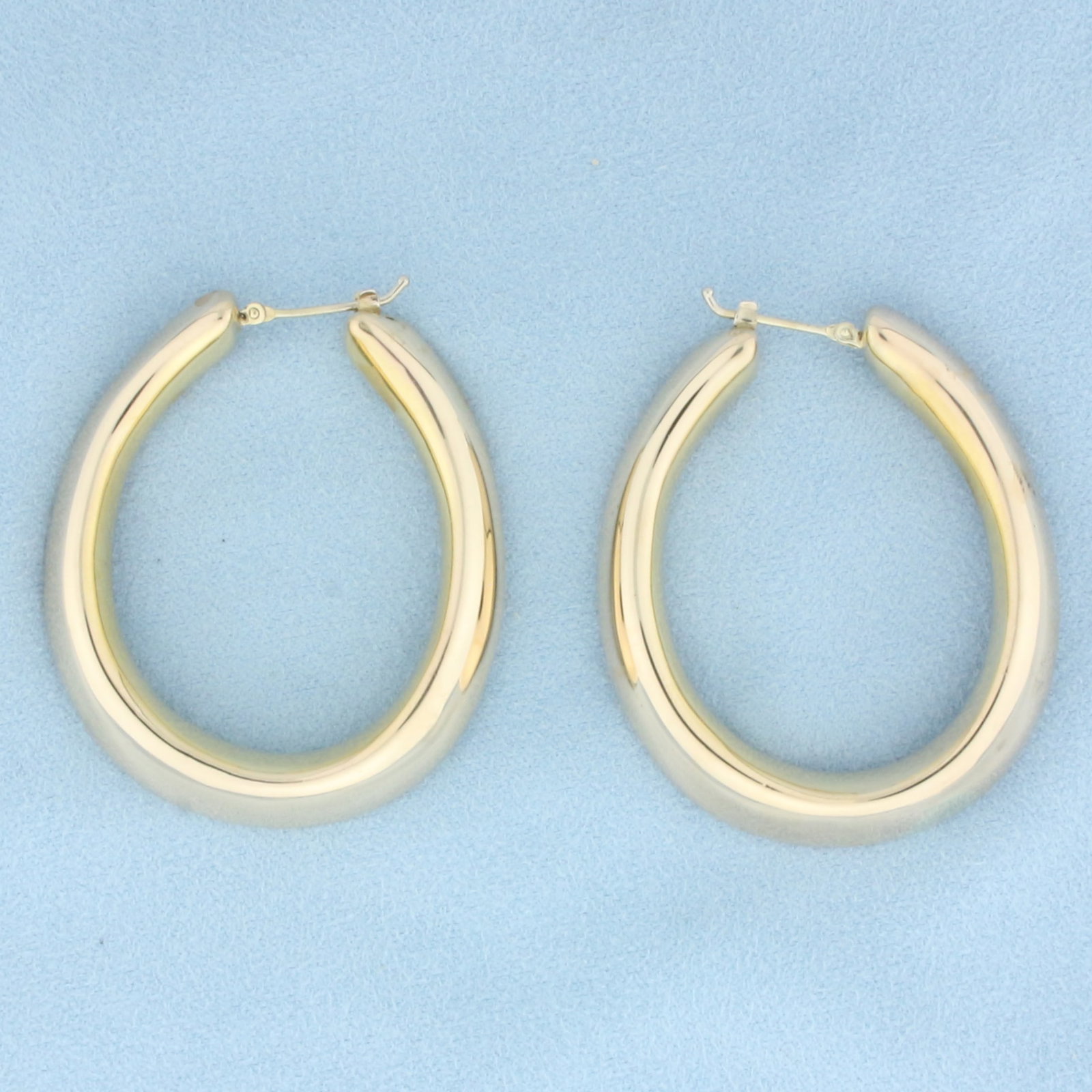 Large Italian Hoop Earrings in 14k Yellow Gold: In 14k Yellow Gold. 2 inches long. 1 5/8 inch wide. 7.54mm thick. Leverbacks. 10.6g.