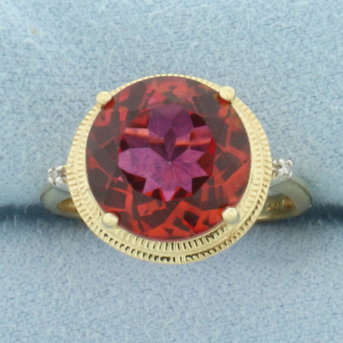 Red Topaz and Diamond Ring in 10k Yellow Gold: In 10k Yellow Gold. Contains one 12mm high quality natural Topaz gemstone, approximately 5cts, with vibrant color and excellent clarity. Also contains two high quality 1/2pt diamonds. Size 7.5. 4.1g.