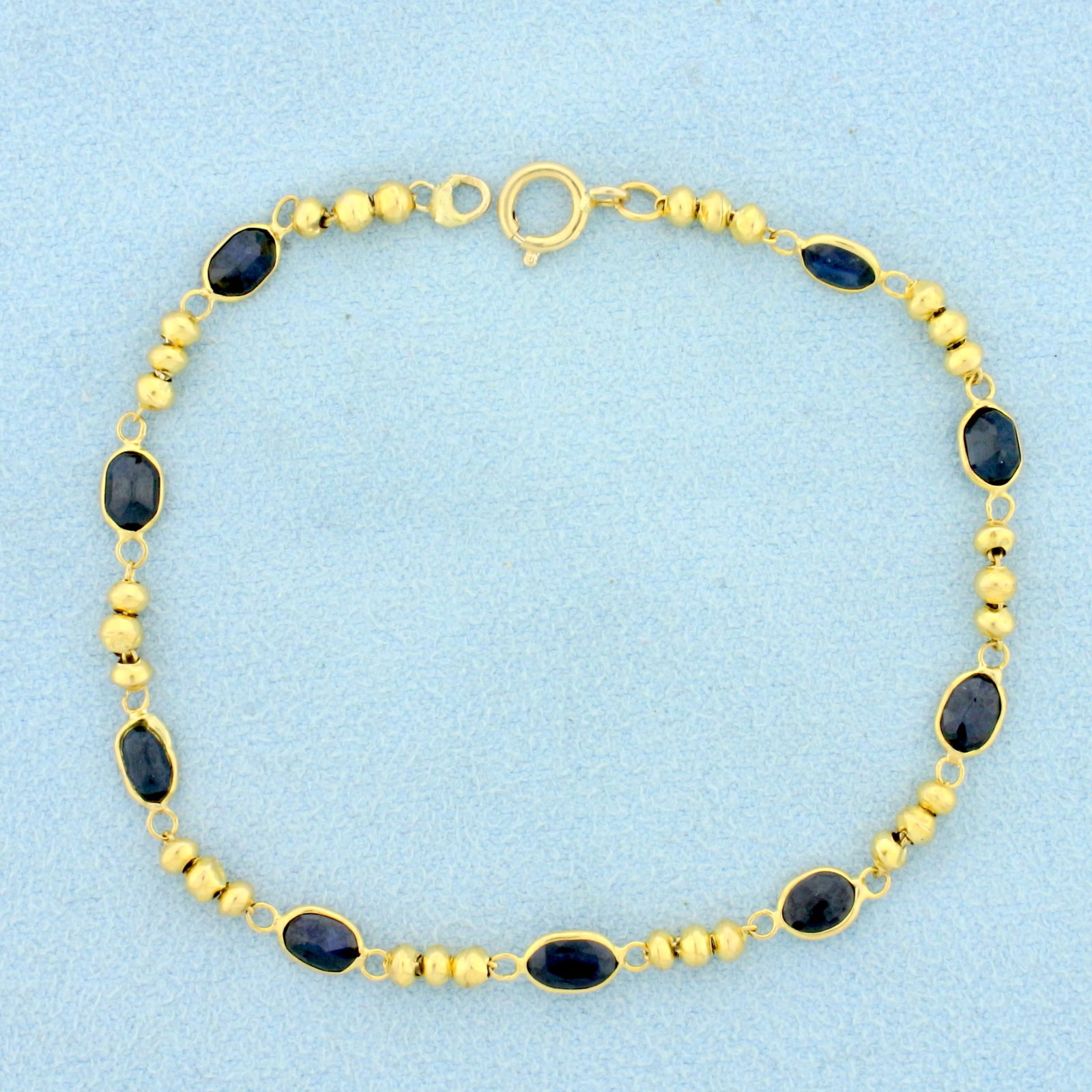 Natural Sapphire Ball Bead Bracelet in 14K Yellow Gold: In 14K Yellow Gold. Contains nine high quality natural oval Sapphire gemstones, approximately 3ct TW, with deep blue color and excellent clarity. 7 inches long. 4mm wide. 2.6g