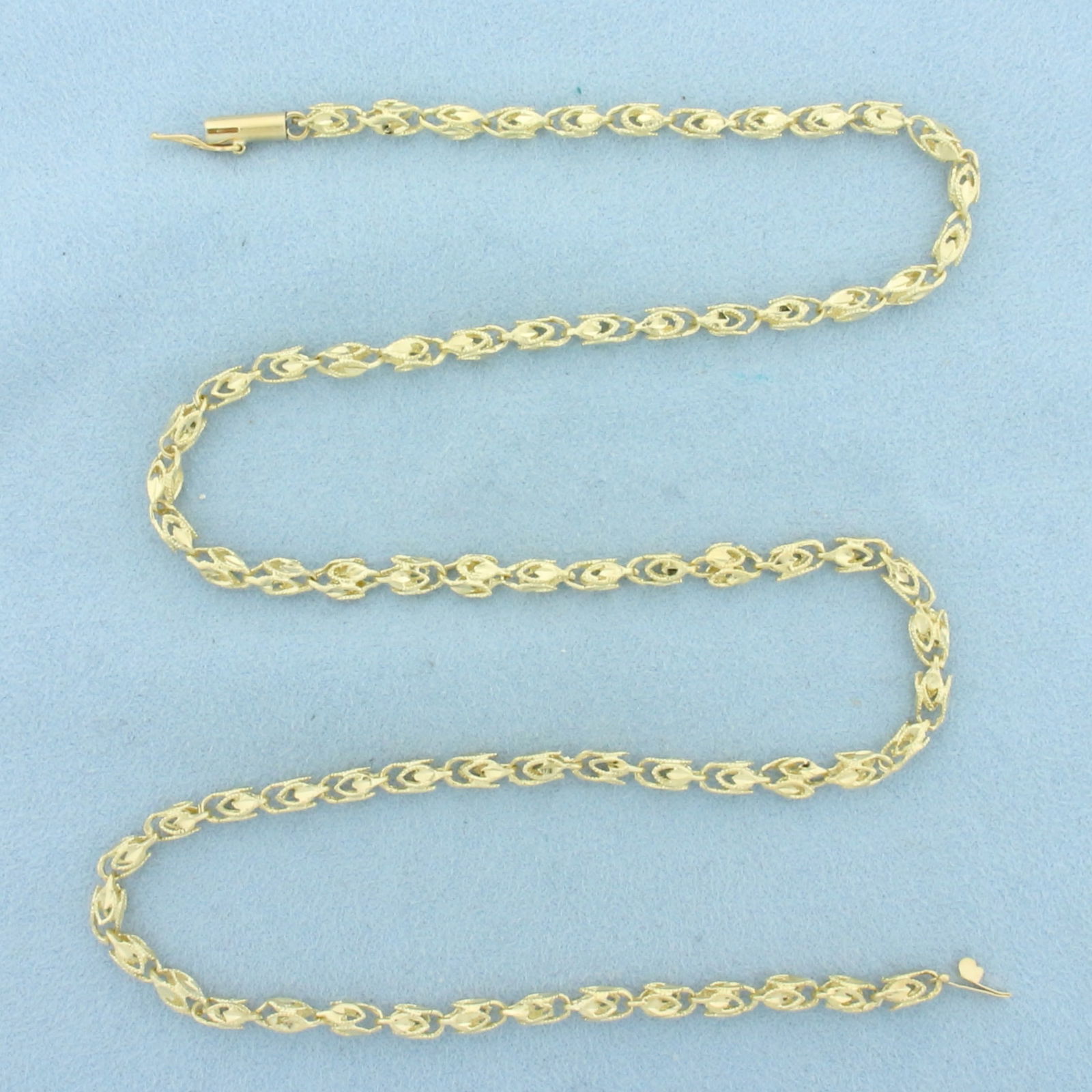 20 Inch Turkish Link Chain Necklace in 14k Yellow Gold: In 14k Yellow Gold. 20 inches long. 4mm wide. Barrel clasp with safety latch. 14.1g.