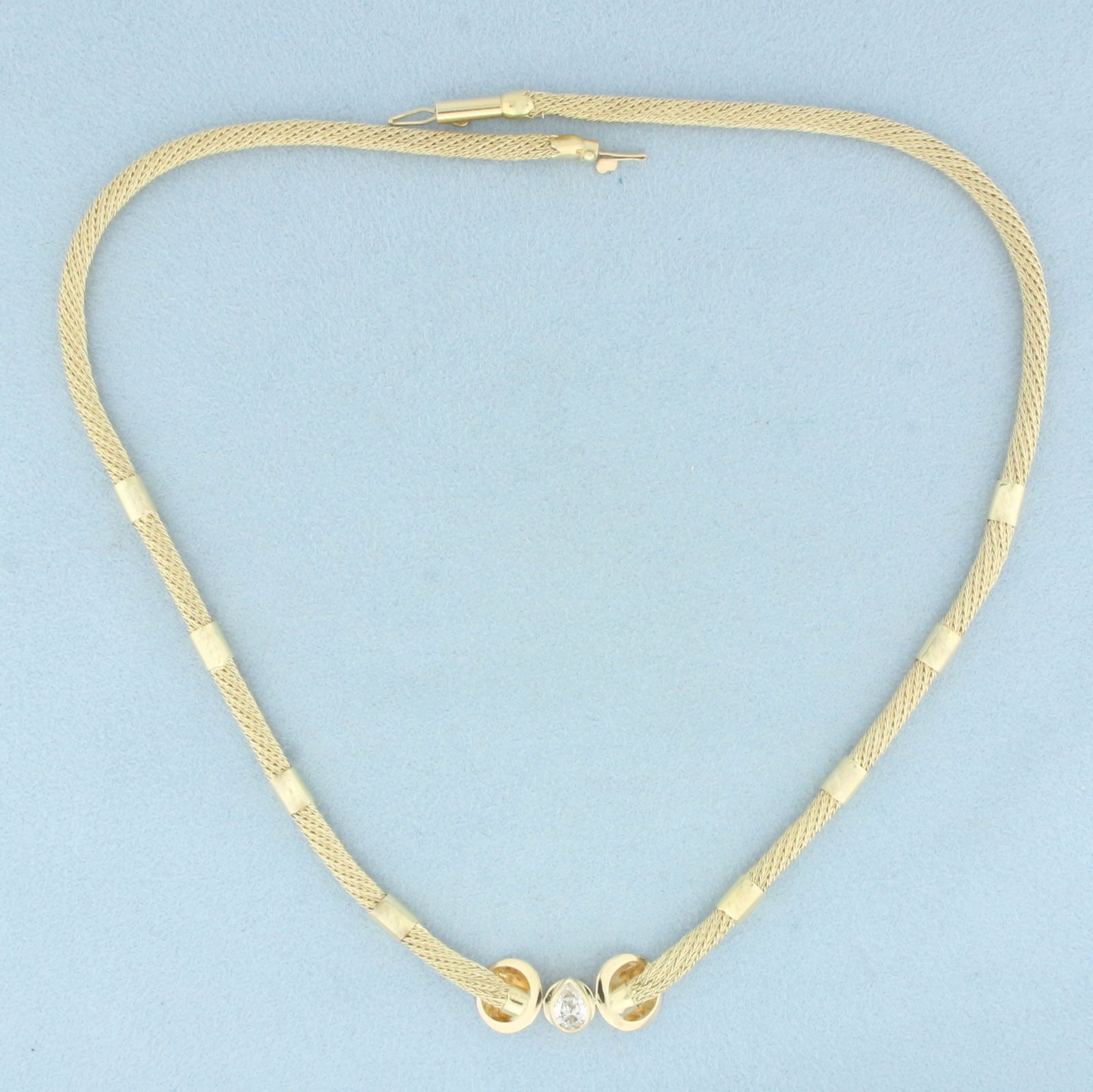 Pear Diamond Mesh Necklace in 14k Yellow Gold: In 14k Yellow Gold. Contains one high quality 1/2ct pear diamond, VS clarity/I color. 16 inches long. 4mm wide. Barrel clasp with safety latch. 15.4g.