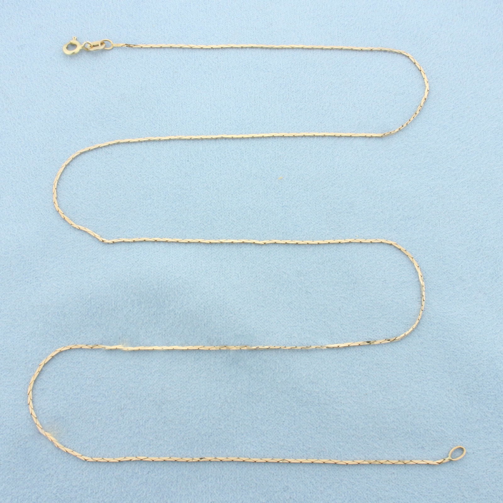 21 Inch Italian Cobra Link Chain Necklace in 14k Yellow Gold: In 14k Yellow Gold. 21 inches long. 0.8mm wide. Made in Italy. Spring clasp. 2.4g.