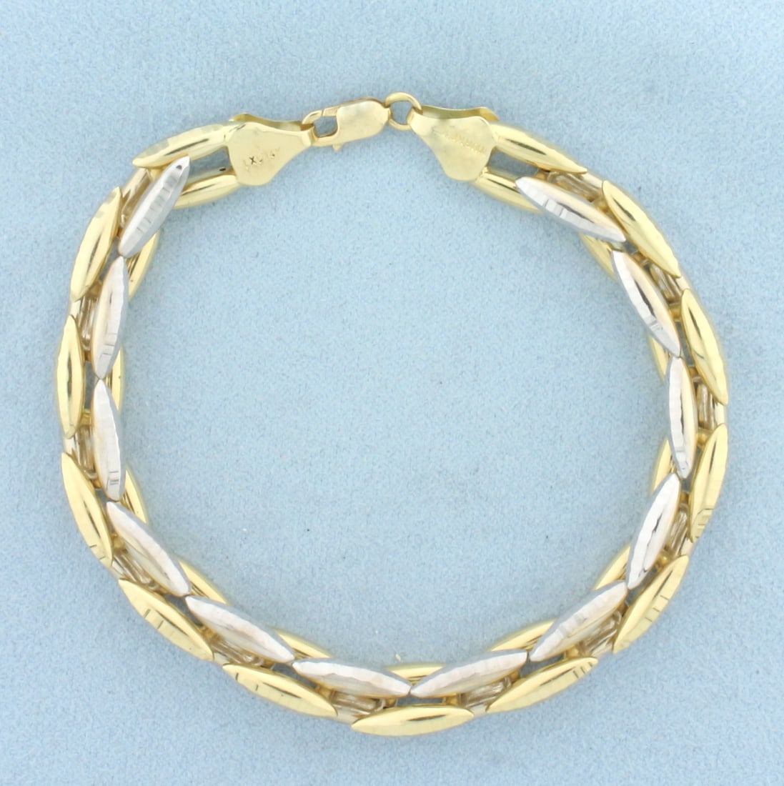 Two Tone Diamond Cut Desinger Link Sparkle Bracelet in 14K Yellow and White Gold: In 14K Yellow and White Gold. 7 1/2 inches long, 8.3mm wide. Lobster clasp. Diamond cut surfaces for sparkle effect. 12.6g.