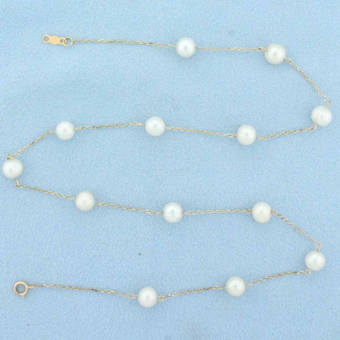 17 Inch Station Cultured Pearl Necklace in 14k Yellow Gold: In 14k yellow gold. Contains 13 cultured Akoya pearls, 6mm each, with high luster. 17 inches long, 1mm think cable link chain. Spring clasp. 1.7g.