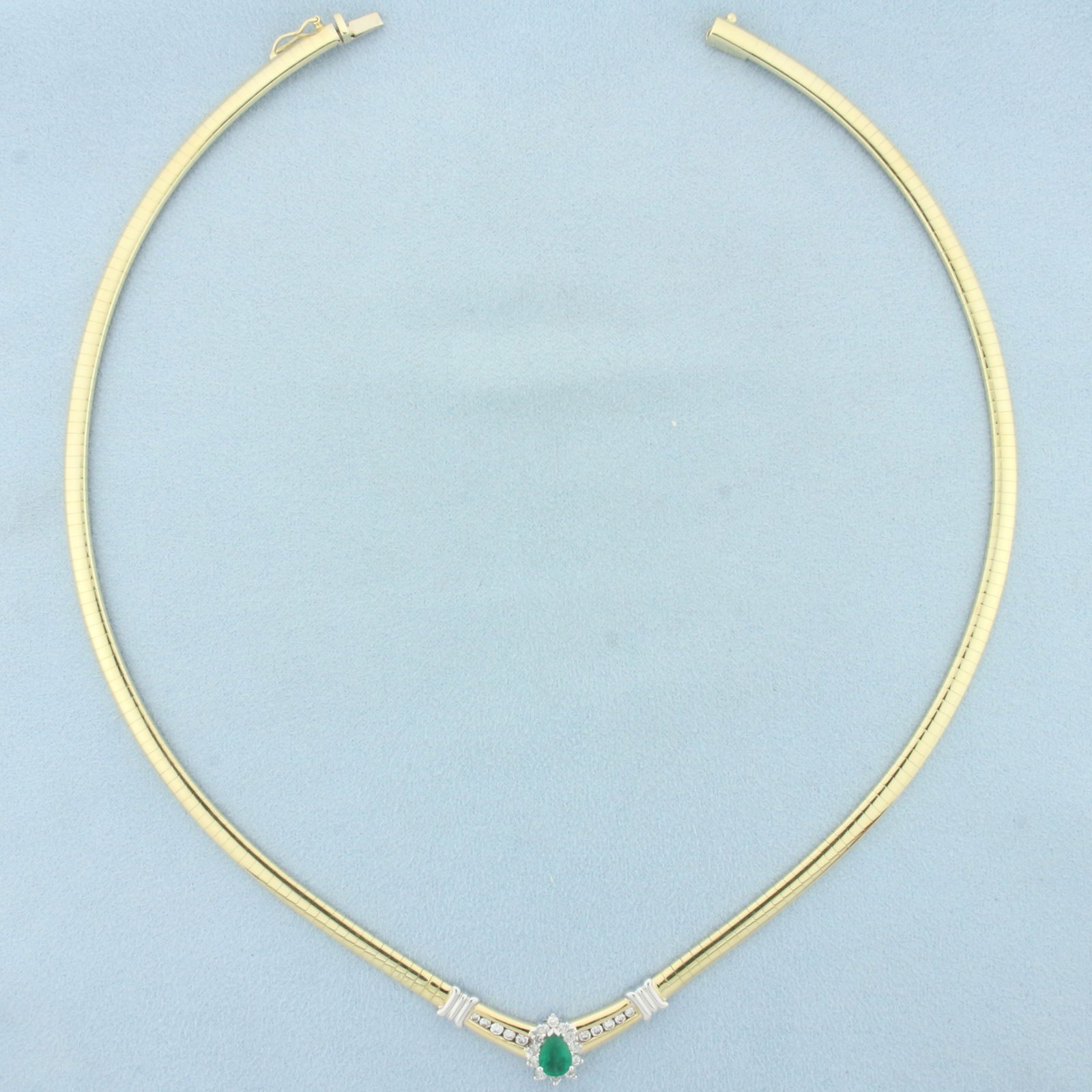 Emerald and Diamond Omega Necklace in 14k Yellow Gold: In 14k yellow gold. 16.5 inches long, 4mm wide. Contains one pear cut high quality natural 1/2ct emerald with vibrant green emerald color. Accented by twenty two high quality .03ct diamonds, VS clarit