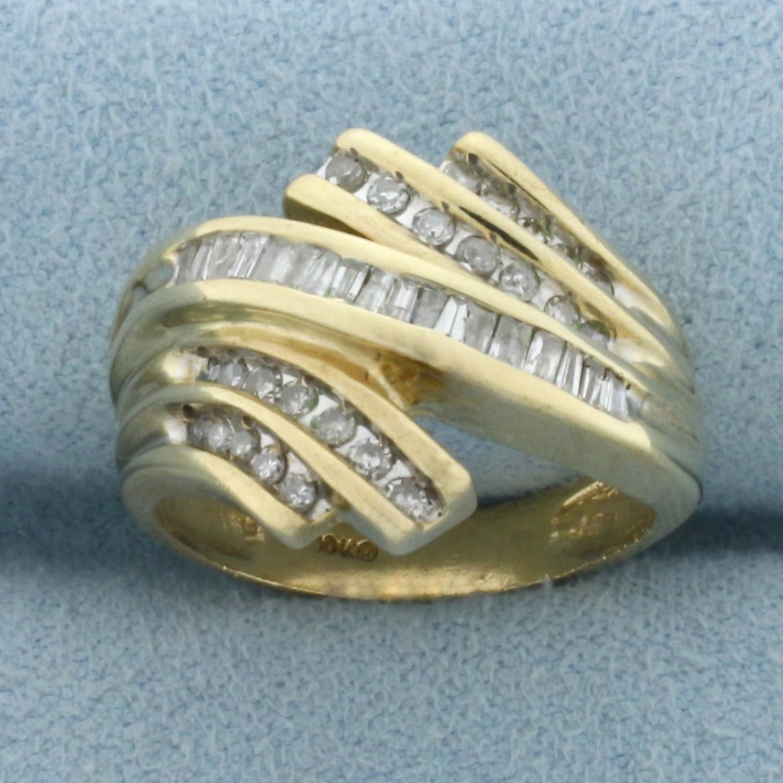 Baguette Diamond Right Hand Ring in 10k Yellow Gold: In 10k Yellow Gold. Contains twenty-four round and eighteen baguette high quality diamonds, 1/2ct TW, I color/I clarity. 15mm wide at widest spread. Size 6. 4.8g.