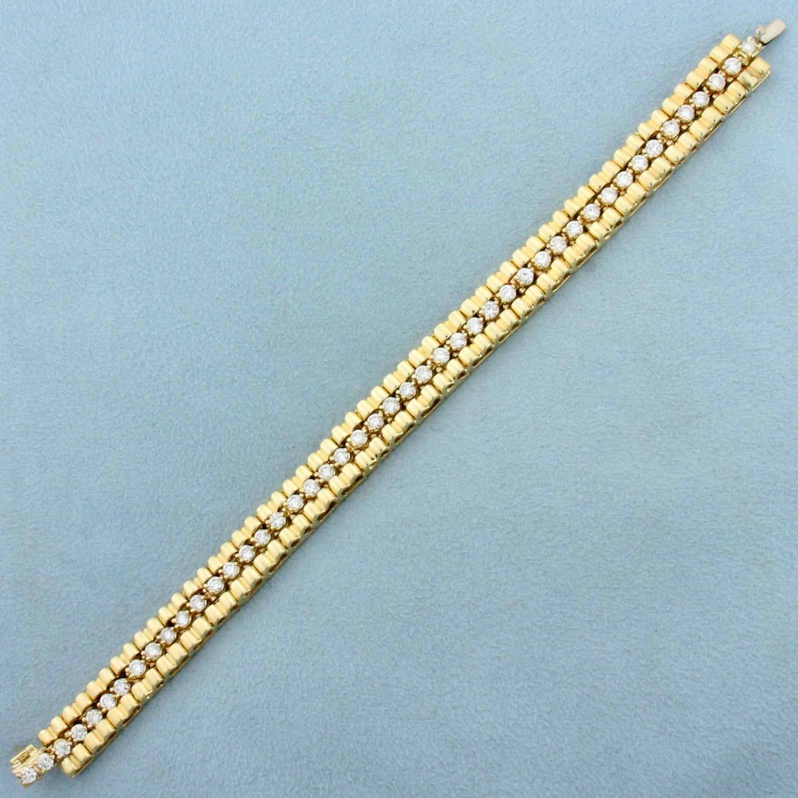 Tank Track Diamond Line Tennis Bracelet in 14K Yellow Gold: In 14K Yellow Gold. Contains forty six high quality diamonds, 3ct TW, SI clarity/G color. 6 7/8 inches long, 9.3mm wide, with safety clasp. 29.2g.