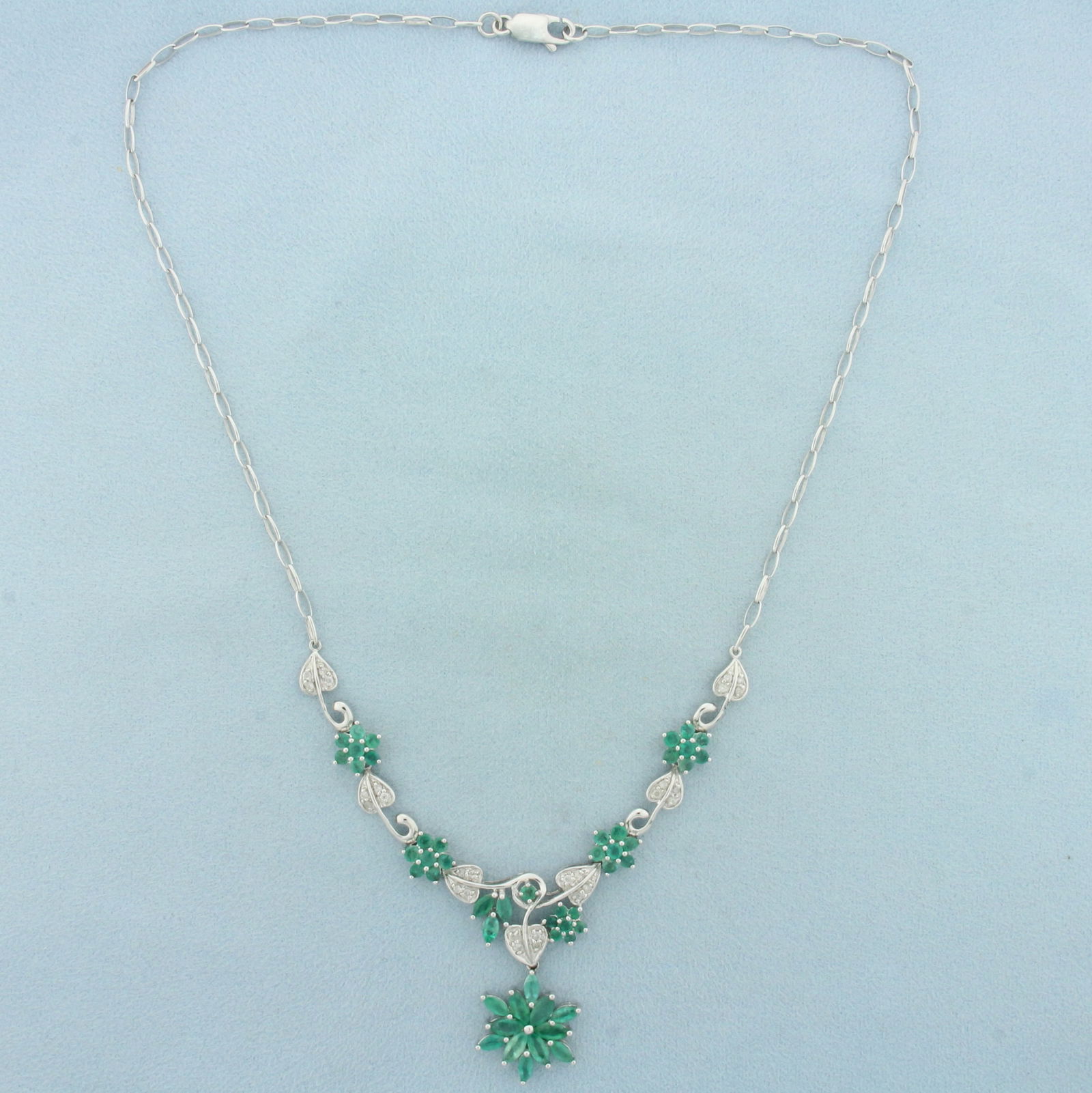 6ct Emerald and Diamond Flower Design Necklace in 14k White Gold: In 14k white gold. Contains fifty one high quality natural Emerald gemstones, 5 3/4ct TW, with vibrant color. Also contains 28 high quality .01ct diamonds, H color/I clarity. 18 inches long. Cable