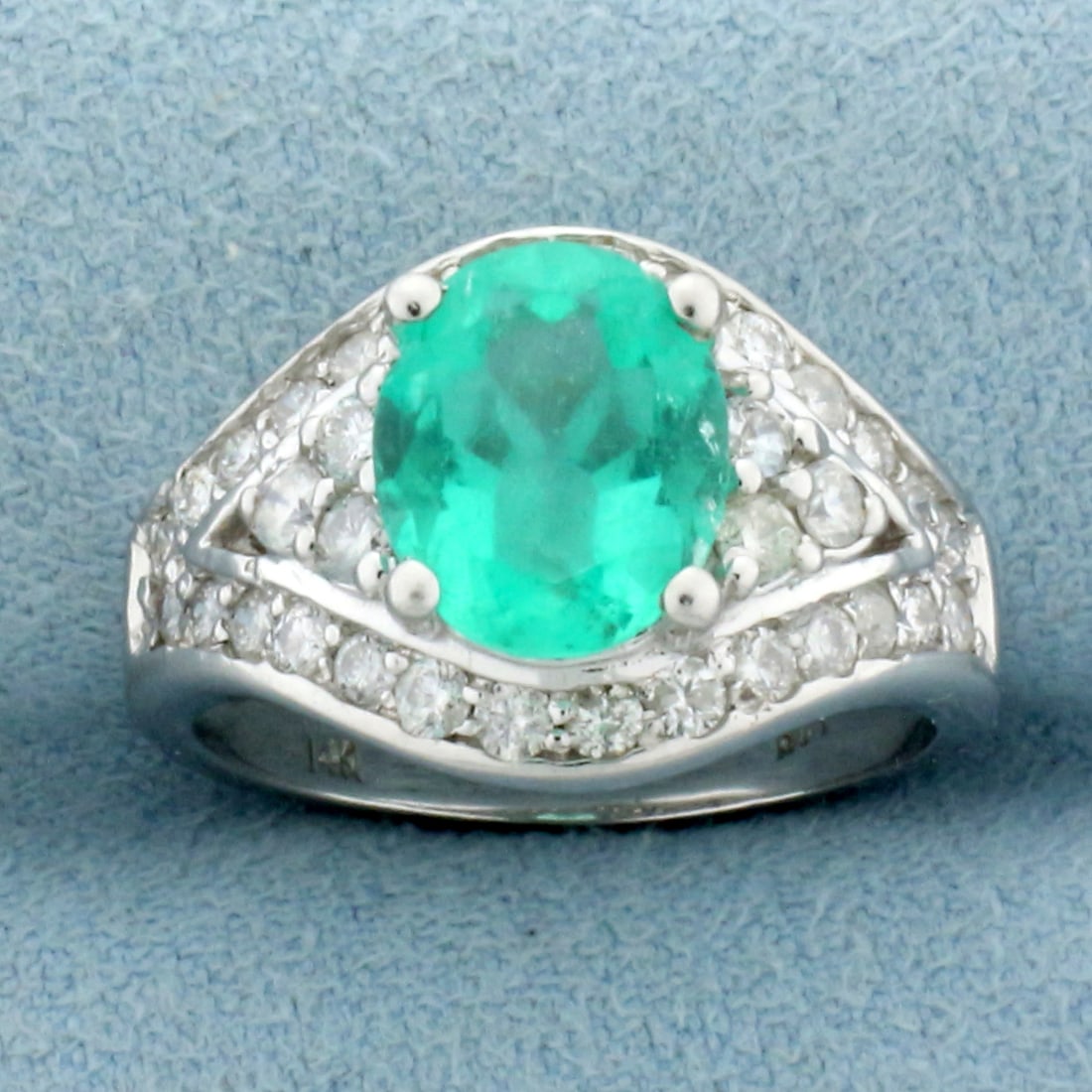 2ct Emerald and Diamond Ring in 14k White Gold: In 14k white gold. Contains 1 high quality natural oval cut emerald, 9.4mm by 7.7mm, approximately 2cts, with vibrant color. Also contains 34 high quality diamonds, 3/4ct TW, VS clarity/G color.