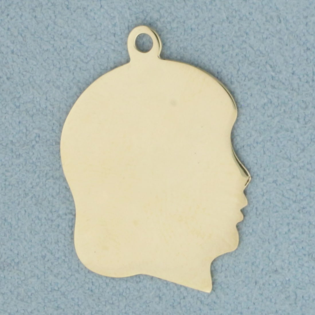 Engravable Girl Head Silhouette Charm or Pendant in 14k Yellow Gold: In 14k Yellow Gold. 1 inch long. 5/8 inch wide. Can engrave name/date on either side. 1.6g.