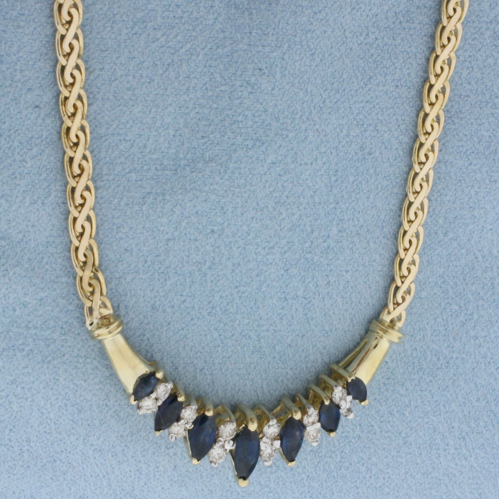 Sapphire and Diamond Necklace in 14k Yellow Gold: In 14k Yellow Gold. Contains one 3x7mm, two 3x6mm, two 2.5x5mm, and two 2x4mm AAA quality natural Sapphire gemstones with intense color an excellent clarity. Also contains twelve high quality diamonds
