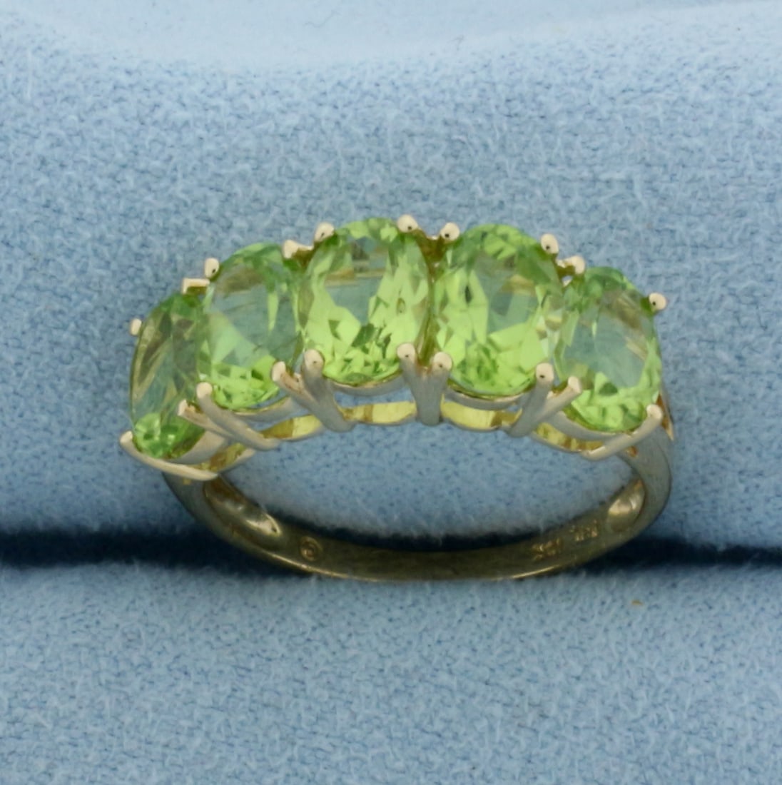 Peridot Line Ring in 10K Yellow Gold: In 10k yellow gold. Contains 5 high quality natural 7mm Peridot gemstones, approximately 5ct TW, with bright color and excellent clarity. Size 6.75. 3.0g.