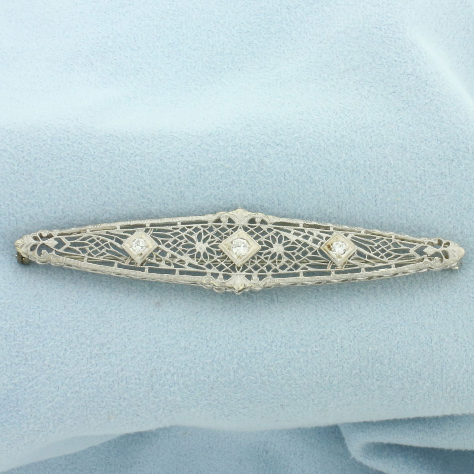 Vintage Filigree Diamond Pin in 14k White Gold: In 14k White Gold. Contains one .08ct and two .04ct high quality diamonds, VS clarity/H color.. 2 1/2 inch long. 1/2 inch wide. 4.5g.