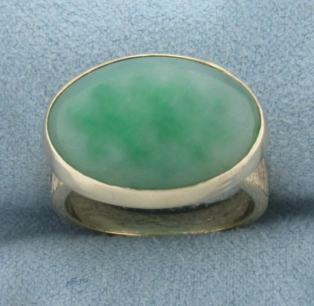 Jade Solitaire Ring in 14k Yellow Gold: In 14k Yellow Gold. Contains one 19x13mm high quality natural Jade gemstone with beautiful green color. Size 6.5. 7.6g.