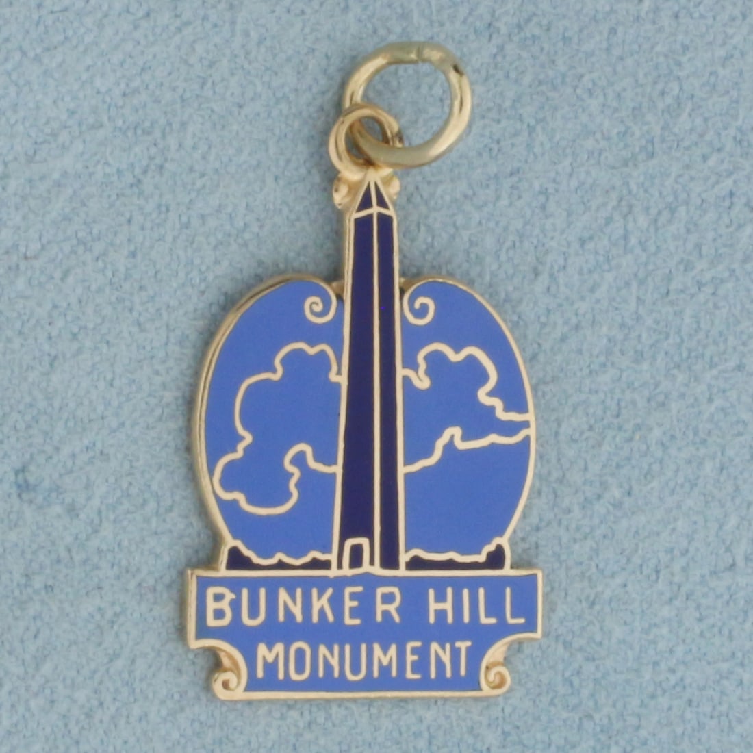 Bunker Hill Monument Charm or Pendant in 14k Yellow Gold: In 14k Yellow Gold. 1 1/8 inch long including jump ring. 5/8 inch wide. 2.9g.