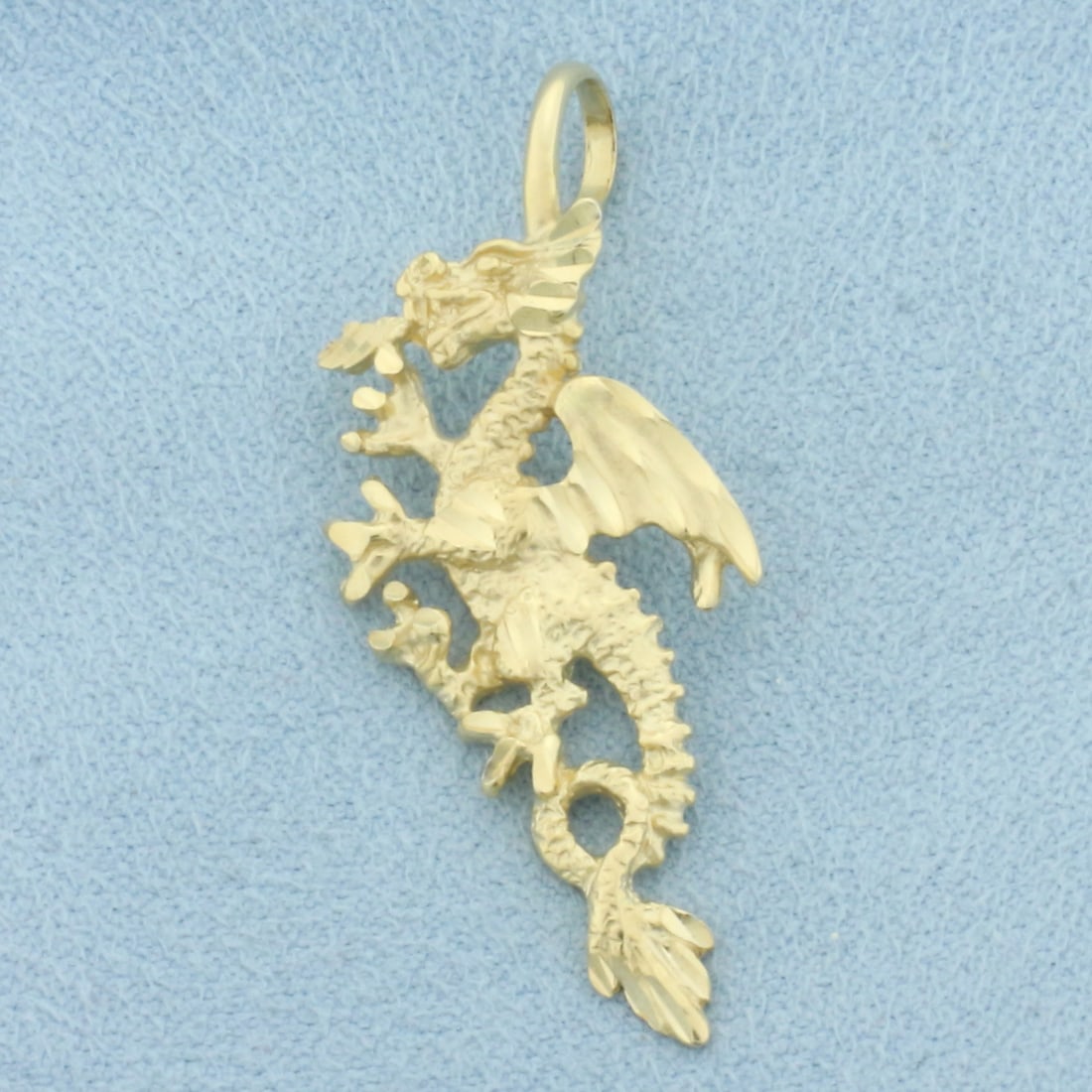 Diamond Cut Dragon Pendant in 14k Yellow Gold: In 14k Yellow Gold. 1 1/2 inch long (including bale). 5/8 inch wide (at widest). 2.7g.