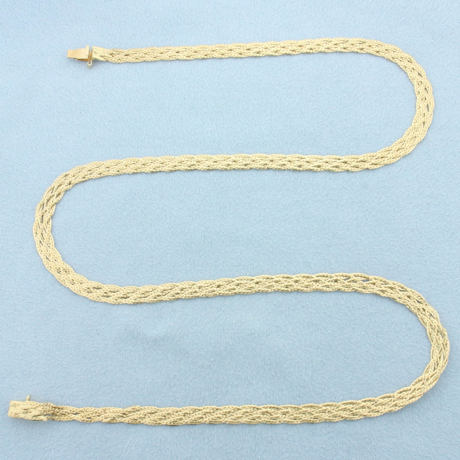 18 Inch Braided Chain Necklace in 14k Yellow Gold: In 14k Yellow Gold. 18 inches long. 4mm wide. Slide clasp. 8.1g.