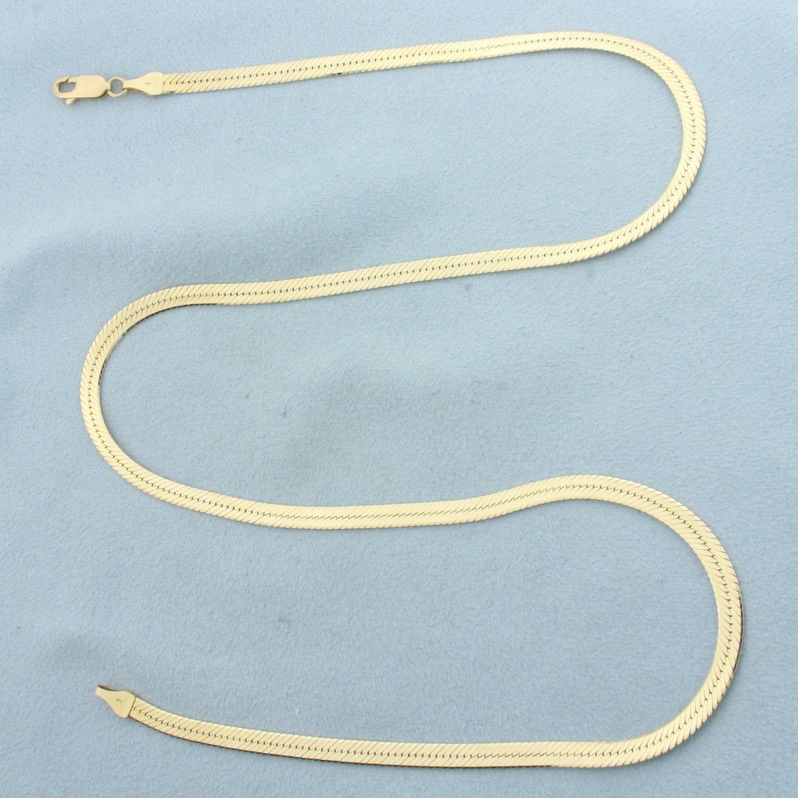 Italian 21 Inch Herringbone Link Chain Necklace in 14k Yellow Gold: In 14k Yellow Gold. 21 inches long. 3.9mm wide. Made in Italy. Lobster clasp. 11.7g.