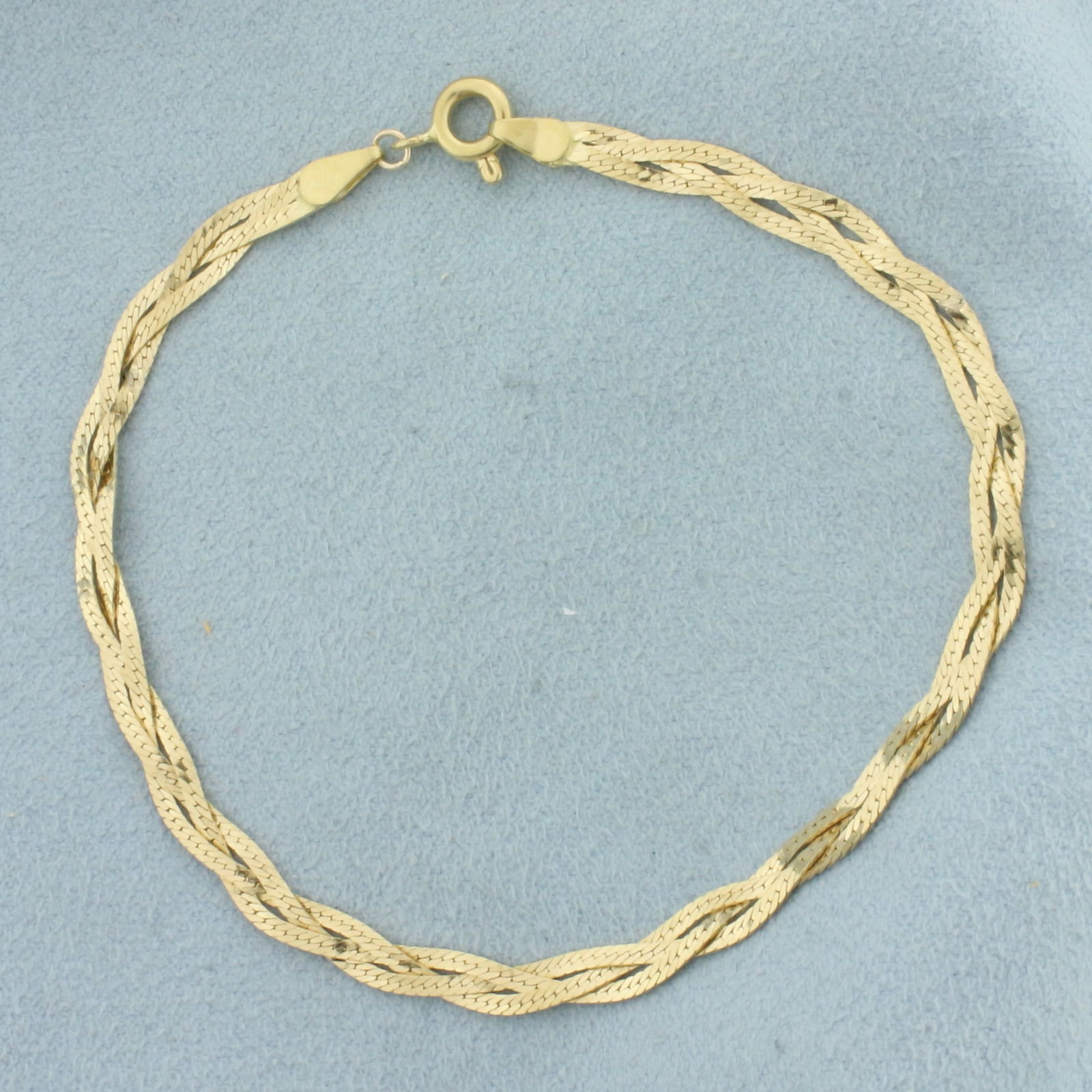Italian Braided Herringbone Link Bracelet in 18K Yellow Gold: In 18k yellow gold. 7 5/8 inches long, 3mm wide. Italian made. Spring clasp. 3.7g.
