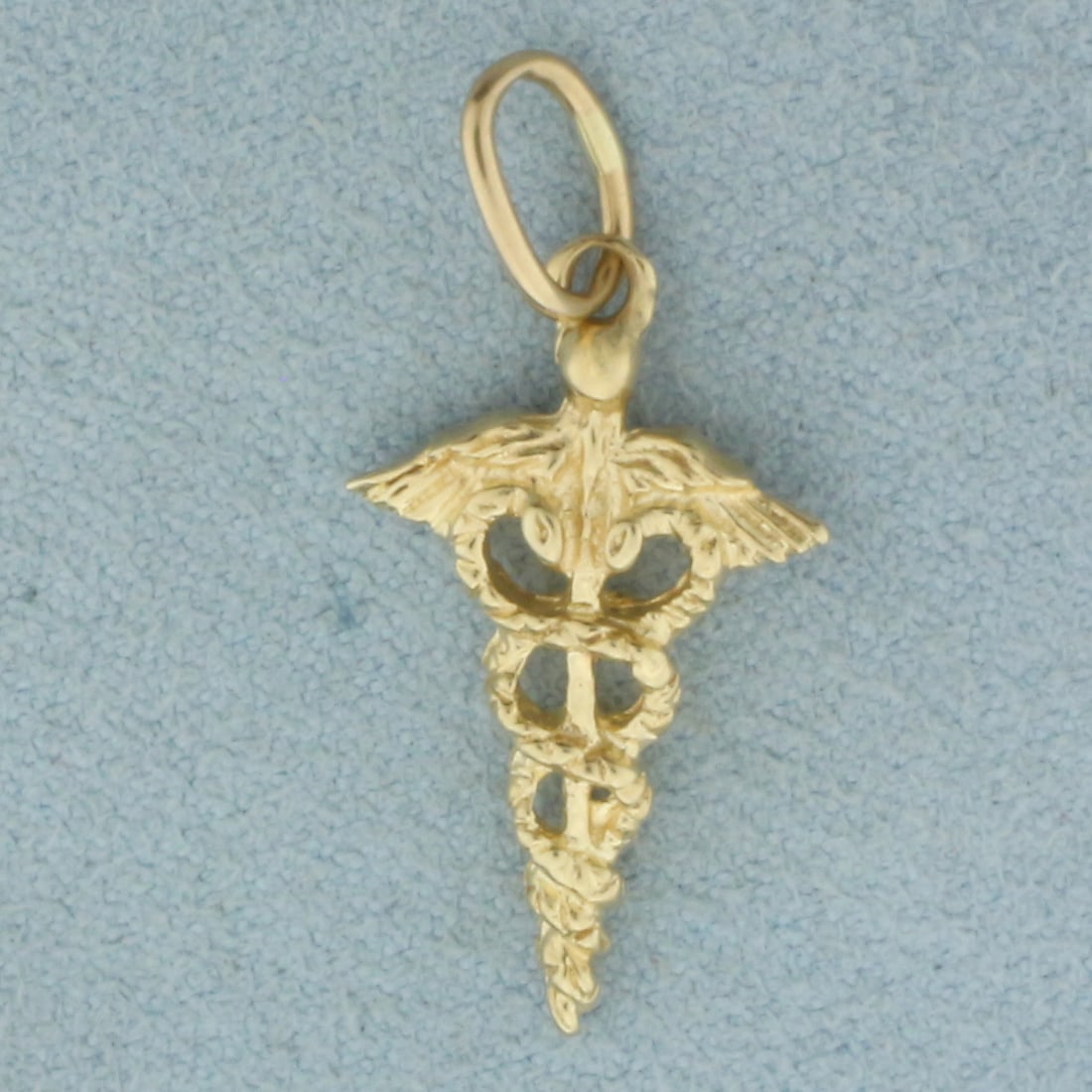 Caduceus Medical Charm or Pendant in 14k Yellow Gold: In 14k Yellow Gold. 1 inch long (including jump ring). 1/2 inch wide. 1.4g.