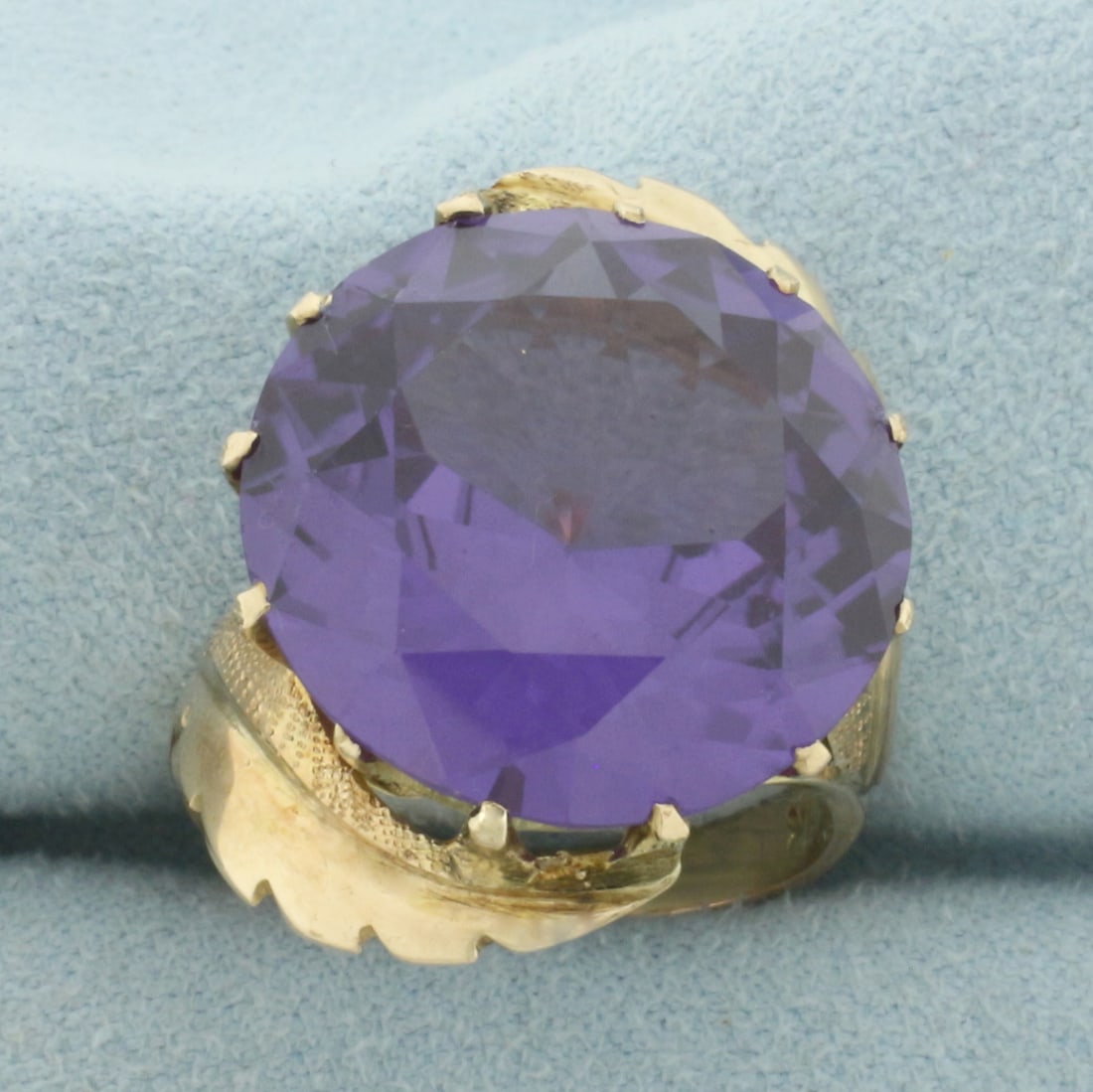 Color Changing Sapphire Ring in 14k Yellow Gold: In 14k Yellow Gold. Contains one 18.3mm high quality natural Purple Sapphire gemstone, approximately 20cts, with intense color change from purple to red and excellent clarity. Size 8. 10.0g.