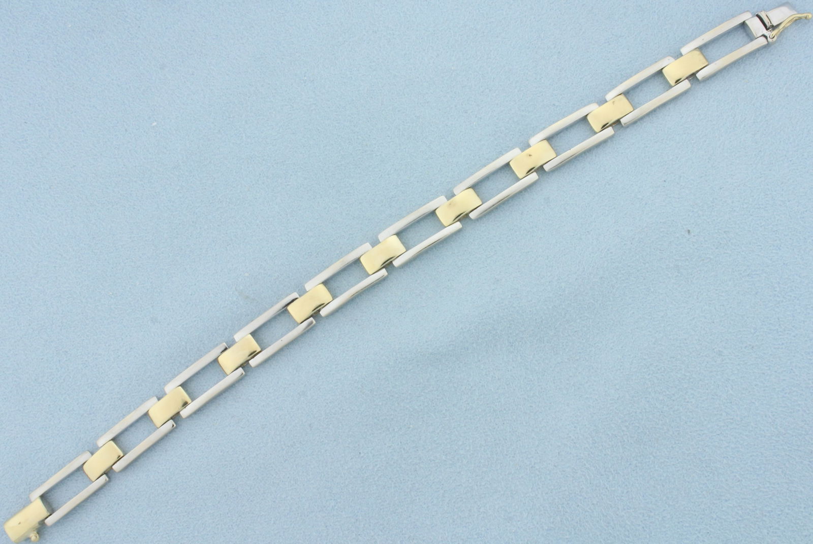 Two Tone Tank Tread Link Bracelet in 14k Yellow and White Gold: In 14k yellow and white gold. 7 1/2 inches long and 8.3mm wide. Safety clasp. 23.8g.