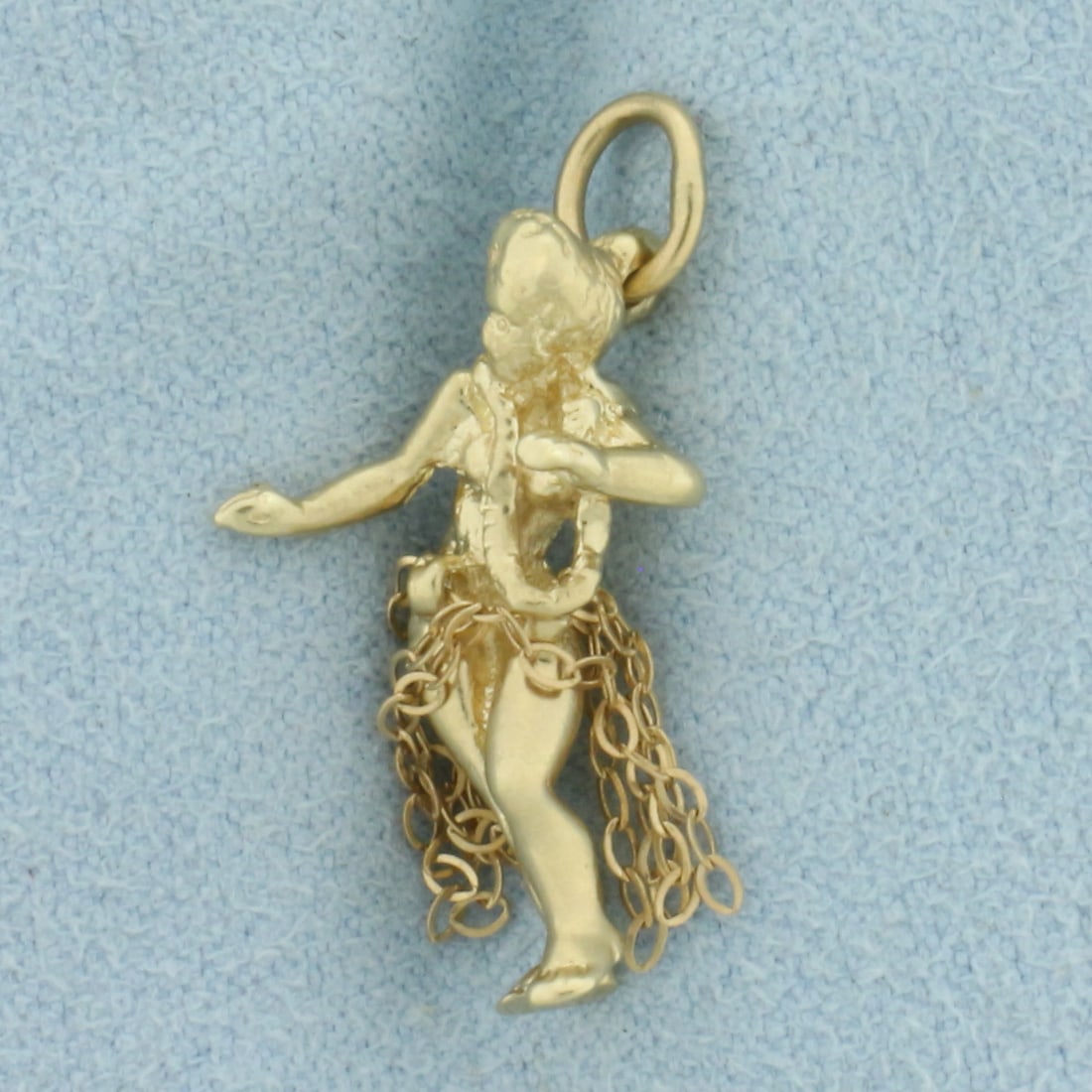 Hula Dancer Charm in 14k Yellow Gold: In 14k Yellow Gold. 3/4 inch long. 1/4 inch wide. Chain skirt. 2.7g.