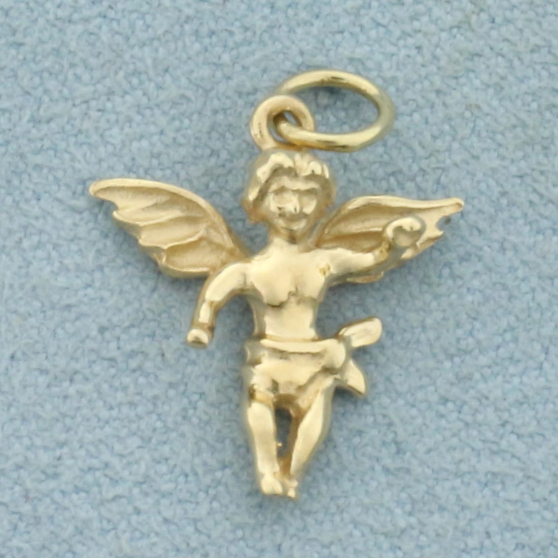 Angel Cherub Charm in 14k Yellow Gold: In 14k Yellow Gold. 3/4 inch long including jump ring. 5/8 inch wide. 1.4g.