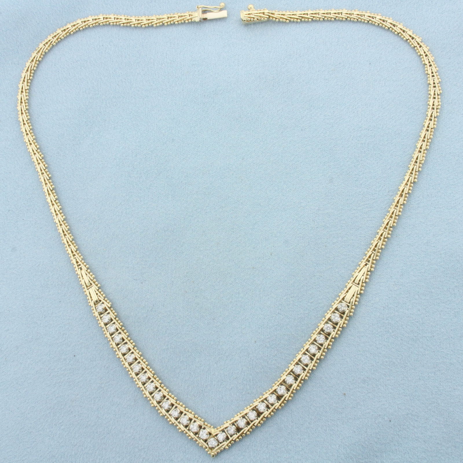 Italian Diamond V Necklace in 14k Yellow Gold: In 14k Yellow Gold. Contains thirty-one high quality diamonds between .03 and .05ct each, 1.25ct TW, VS clarity/G color. 17 inches long. Italian made. Concealed slide clasp with safety latch. 23.9g.