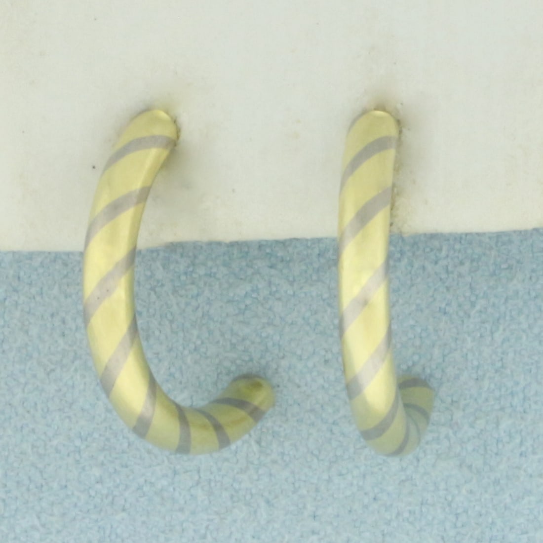 Candy Stripe Design Half Hoop Earrings in 18k Yellow and White Gold: In 18k Yellow and White Gold. 3/4 inch long. 2.65mm thick. Solid construction, not hollow. Friction backs. 5.4g.