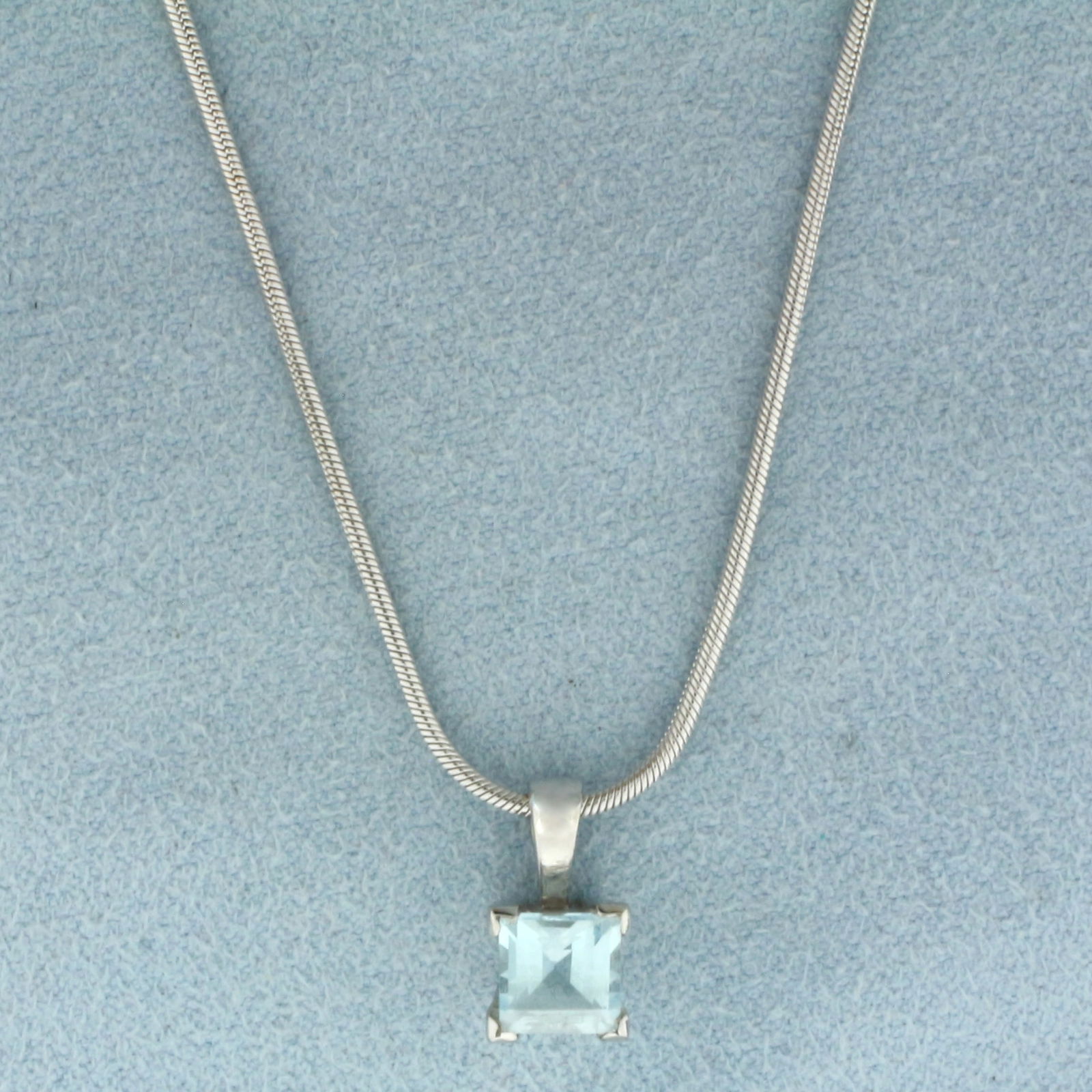 Sky Blue Topaz Necklace in 18k White Gold: In 18k White Gold. Contains one 6mm high quality natural Sky Blue Topaz gemstone with bright color and excellent clarity. Pendant is 12mm by 7mm. Snake link chain is 16 inches long chain, 1mm wide. Lo