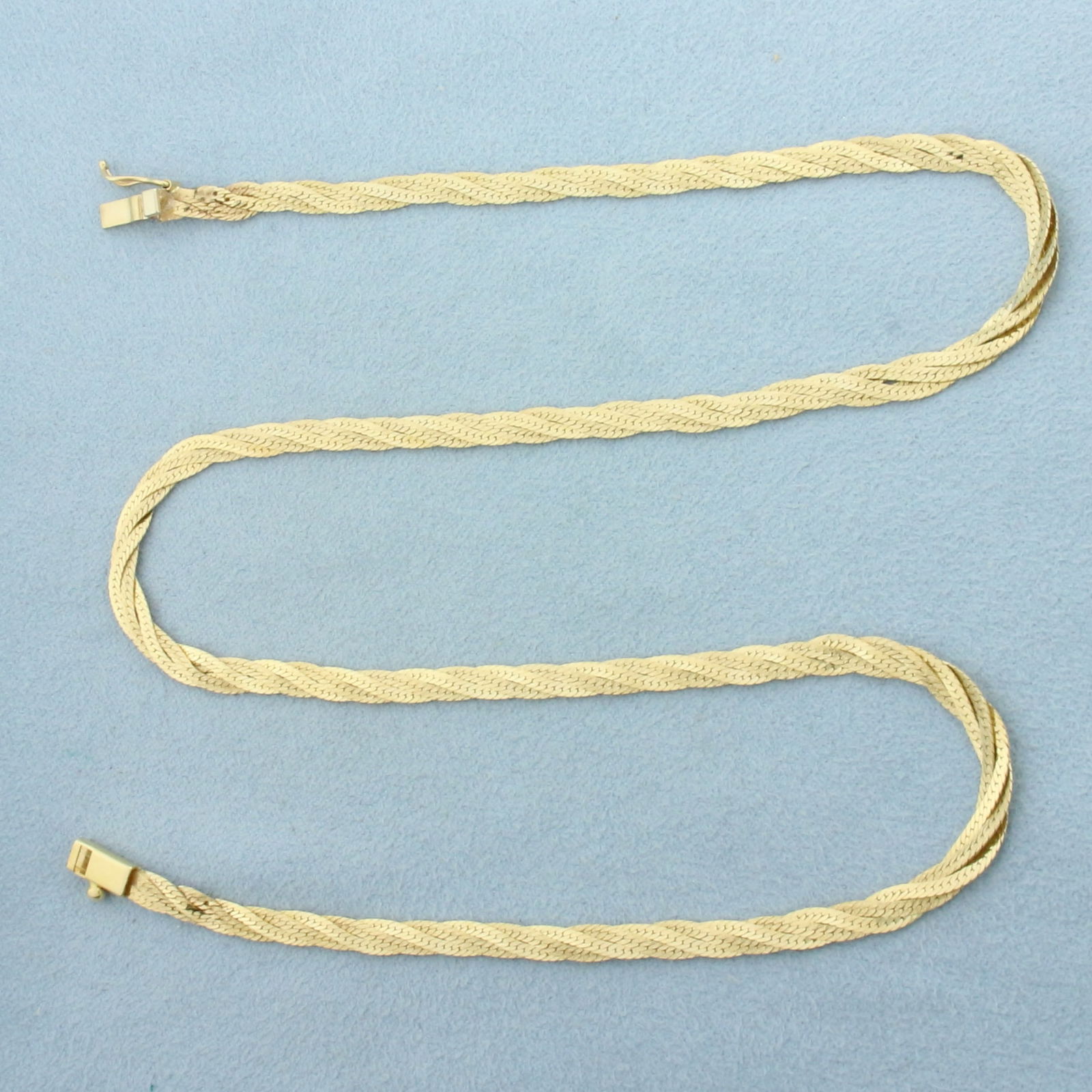 18 Inch Braided Herringbone Link Chain Necklace in 14k Yellow Gold: In 14k yellow gold. 18 inches long. 1/8 inch wide. Italian made. One strand is high polish, one strand is matte finish for unique look. Slide clasp with safety latch. 9.3g.