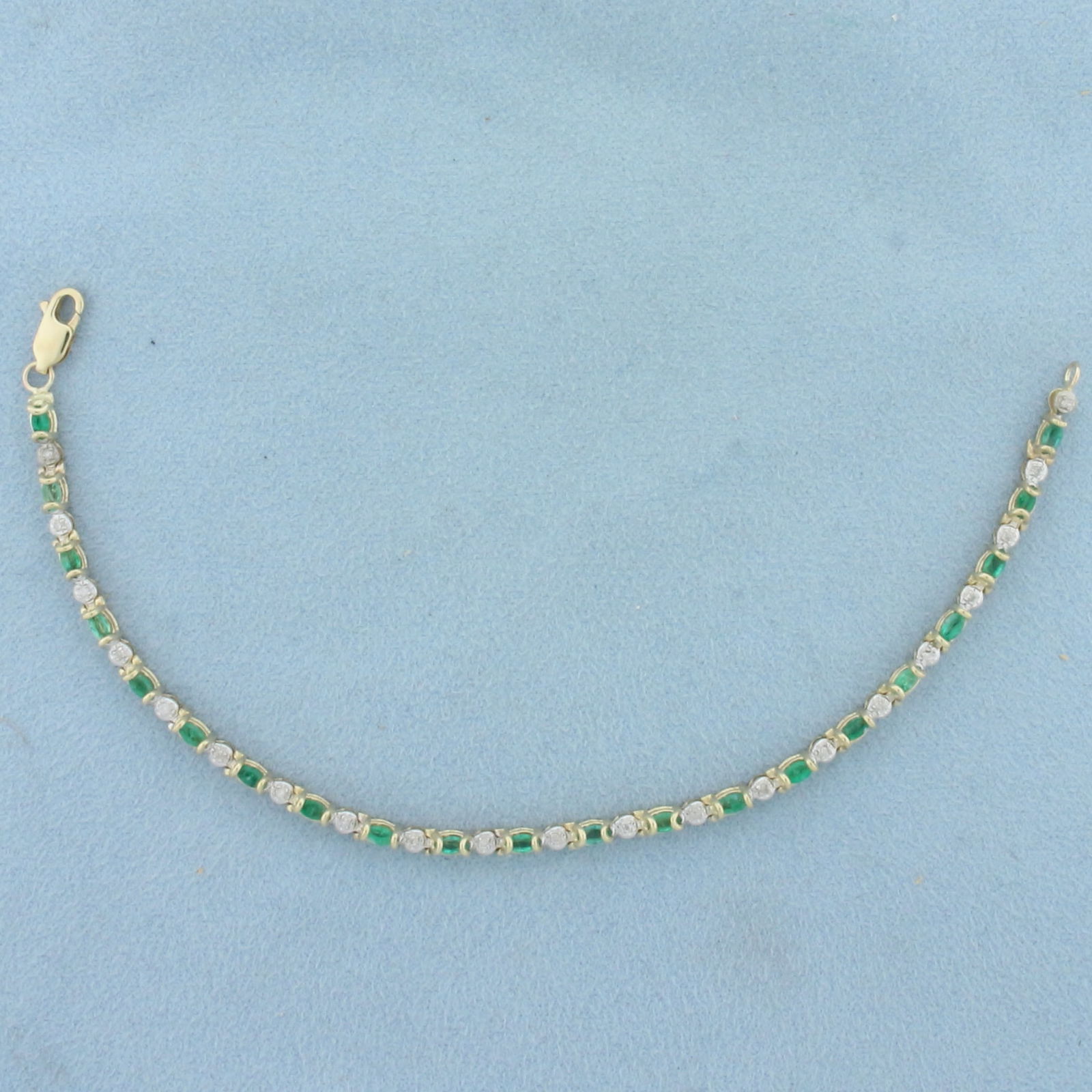 Emerald and Diamond Line Bracelet in 10k Yellow Gold: In 10k Yellow Gold. Contains twenty-two 4mm high quality oval natural Emerald gemstones, approximately 1.5ct TW, with vibrant color. Also contains twenty-two high quality 1/2pt diamonds. 7 inches long