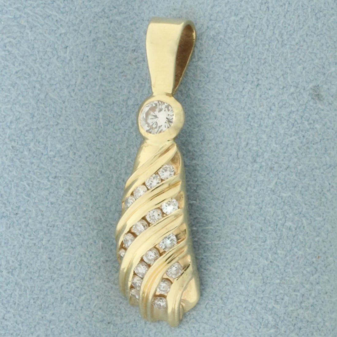 Designer Diamond Pendant in 14k Yellow Gold: In 14k Yellow Gold. Contains one 1/5ct and seventeen .02ct high quality diamonds, VS clarity/H color. 1 1/8 inch long. 8mm wide. 2.6g.
